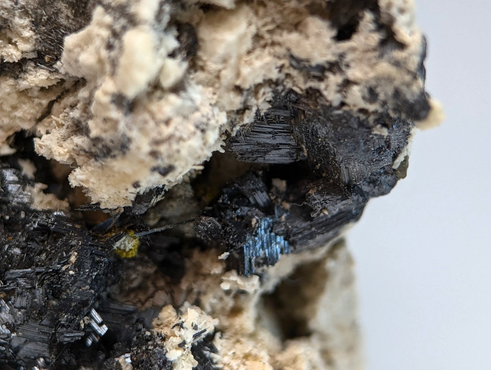 Rutile in matrix from magnet cove arkansas showing a striking black and blue mineral cluster with rough textured matrix