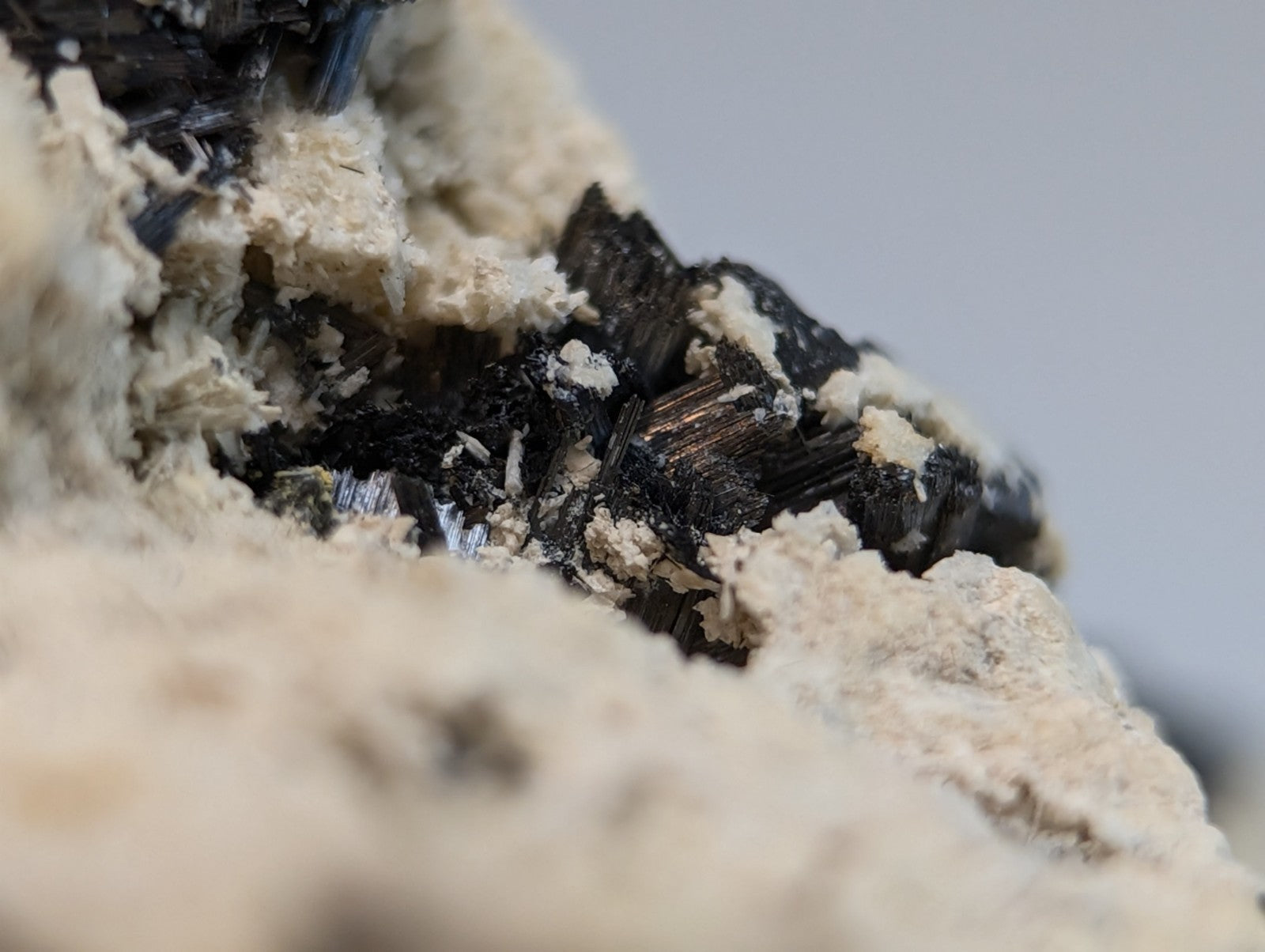 Black crystalline rutile mineral formations in a light beige matrix cluster from magnet cove arkansas super rare old stock