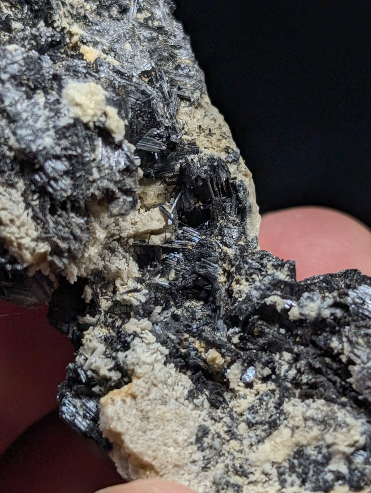 A rugged black and beige mineral specimen with sharp, crystalline textures.