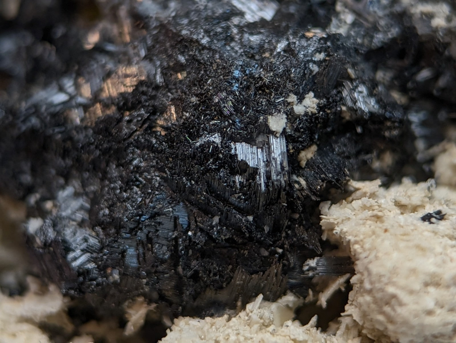 A dark textured rutile mineral cluster with sharp crystalline protrusions in matrix from magnet cove arkansas