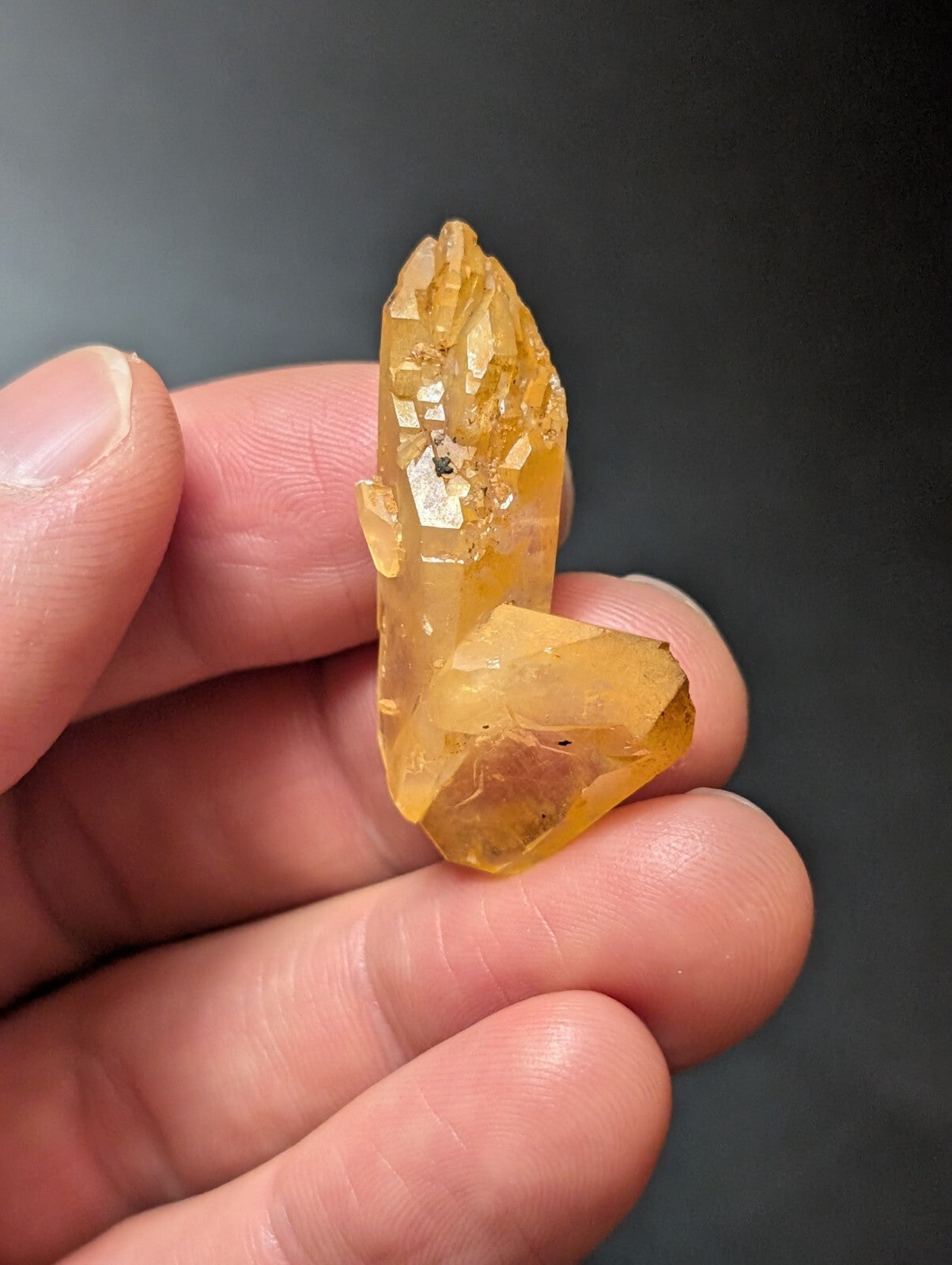 A translucent golden-yellow crystal cluster with sharp, faceted points and a natural, earthy texture.