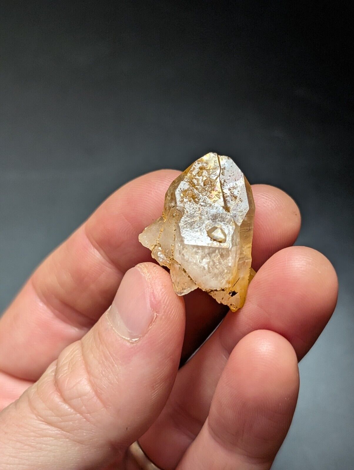 Hand holding a quartz crystal.