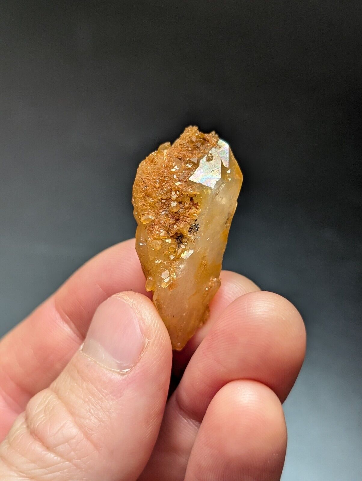 Golden-hued quartz crystal with rough, textured top.