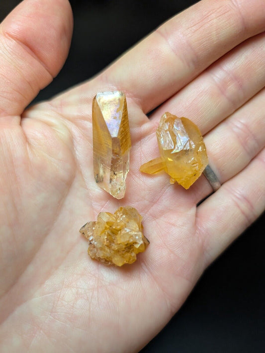 Three golden-hued quartz crystals.