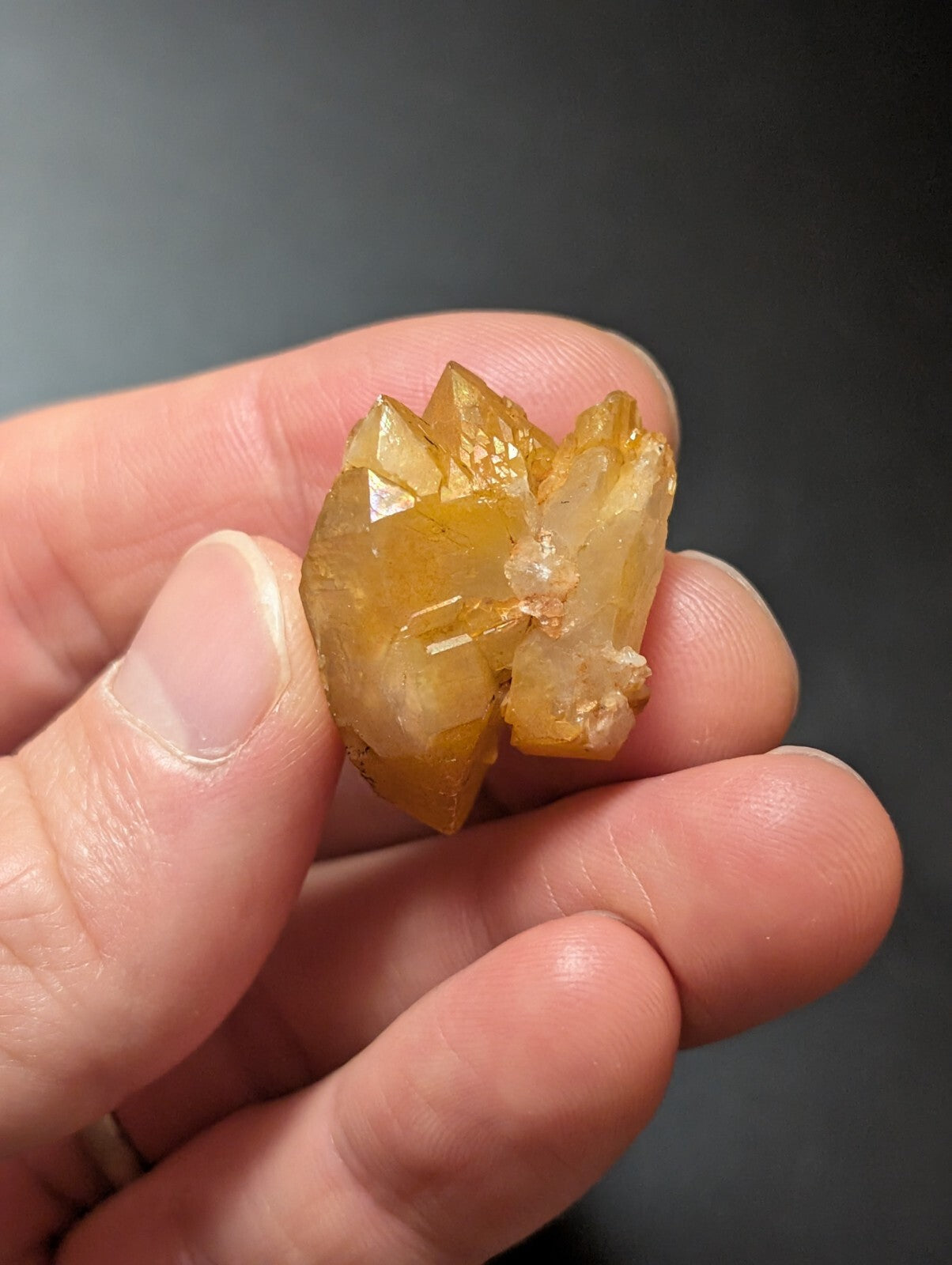 A translucent golden-yellow crystal cluster with sharp, faceted points and a slightly rough texture.