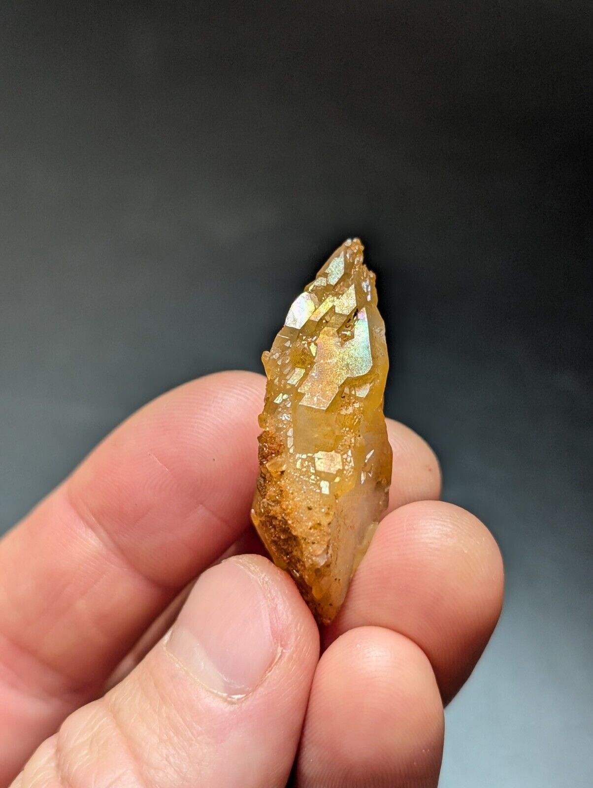 Iridescent quartz crystal point.