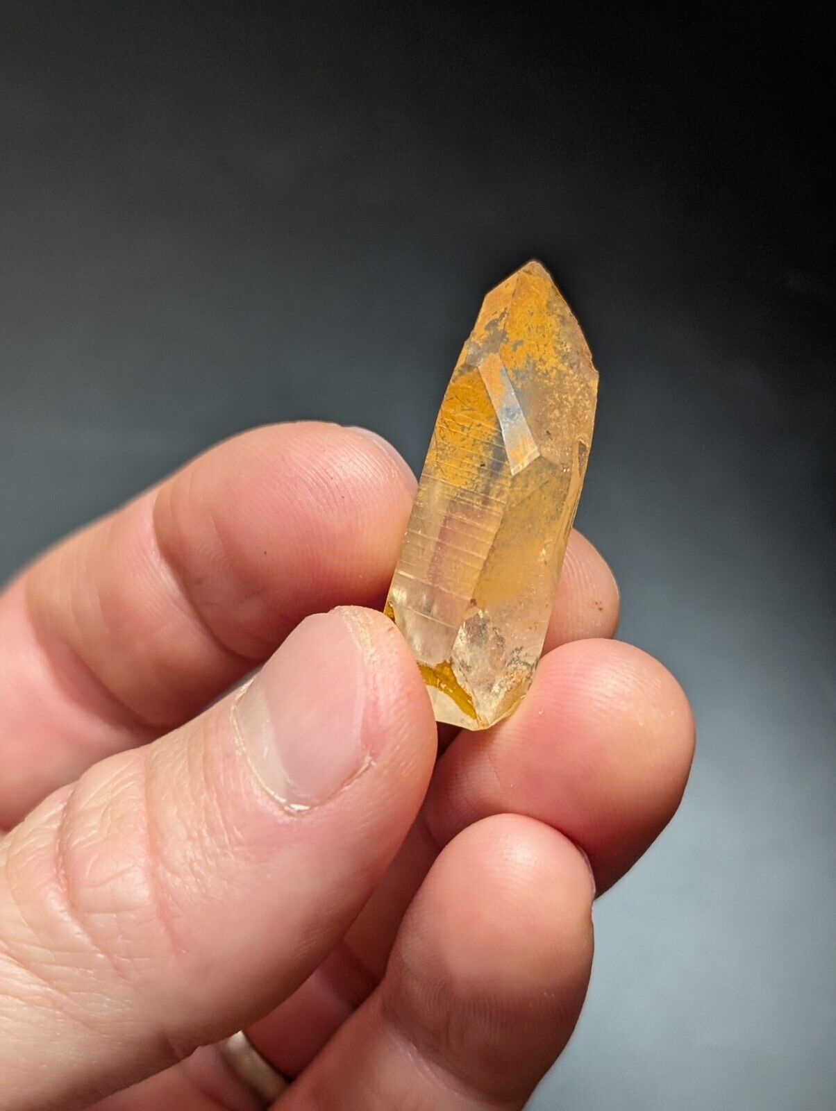 Golden-hued quartz crystal point.