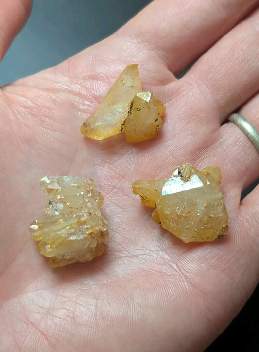 Yellow, translucent crystal specimens with natural facets and embedded mineral inclusions.