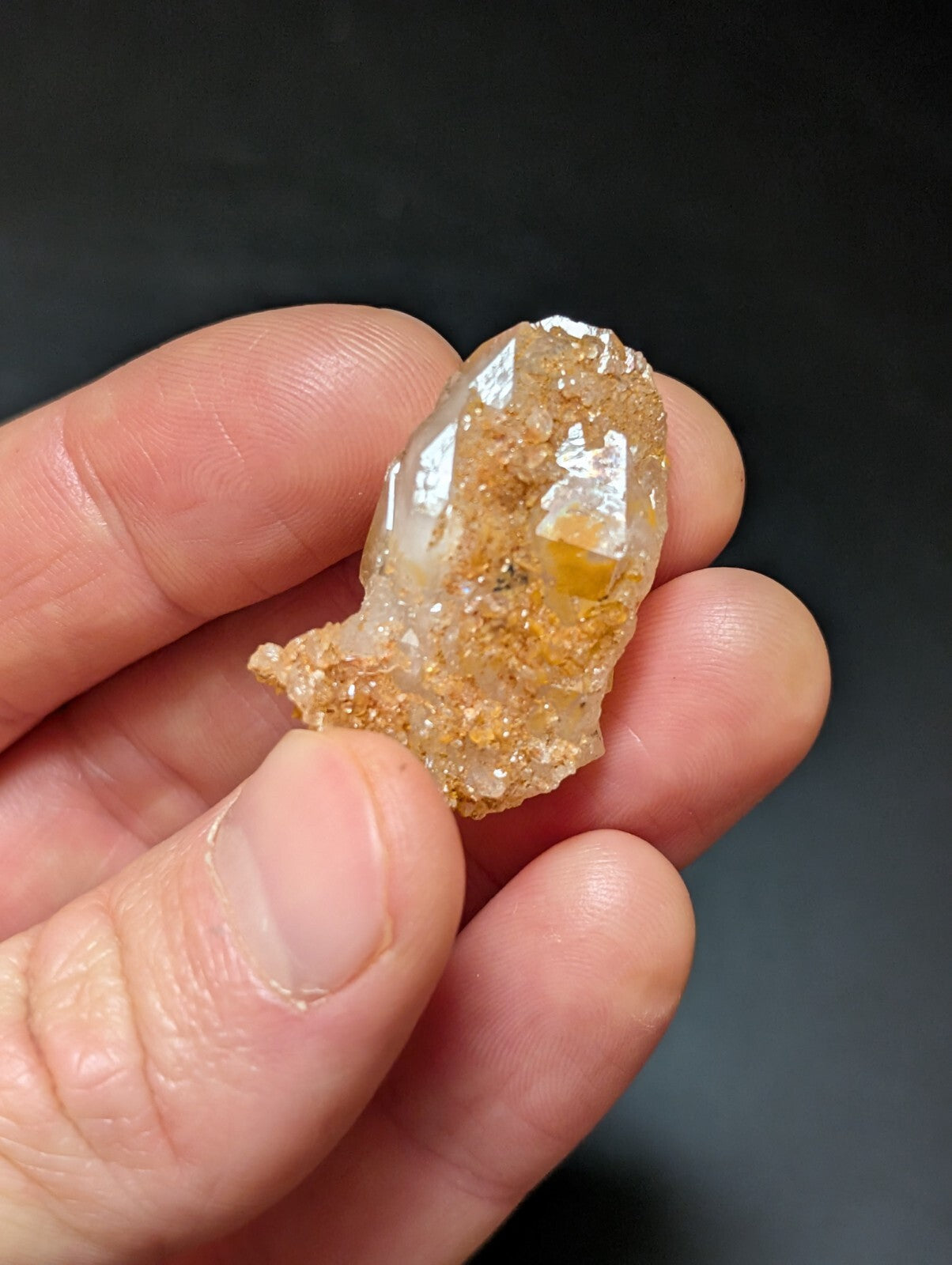 A translucent, amber-hued crystal with a rough, natural surface and visible internal inclusions.
