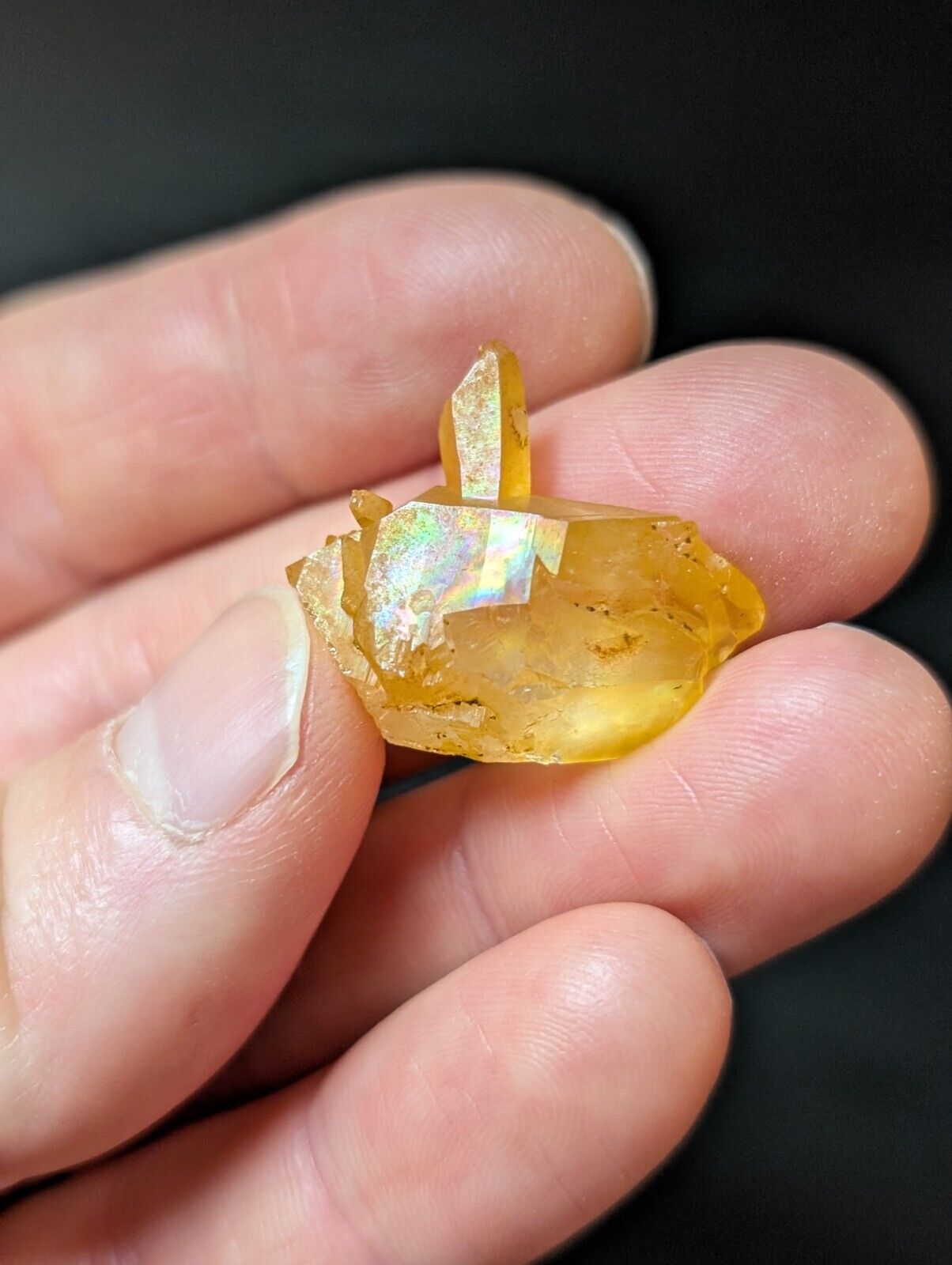 Golden crystal cluster with iridescent sheen.