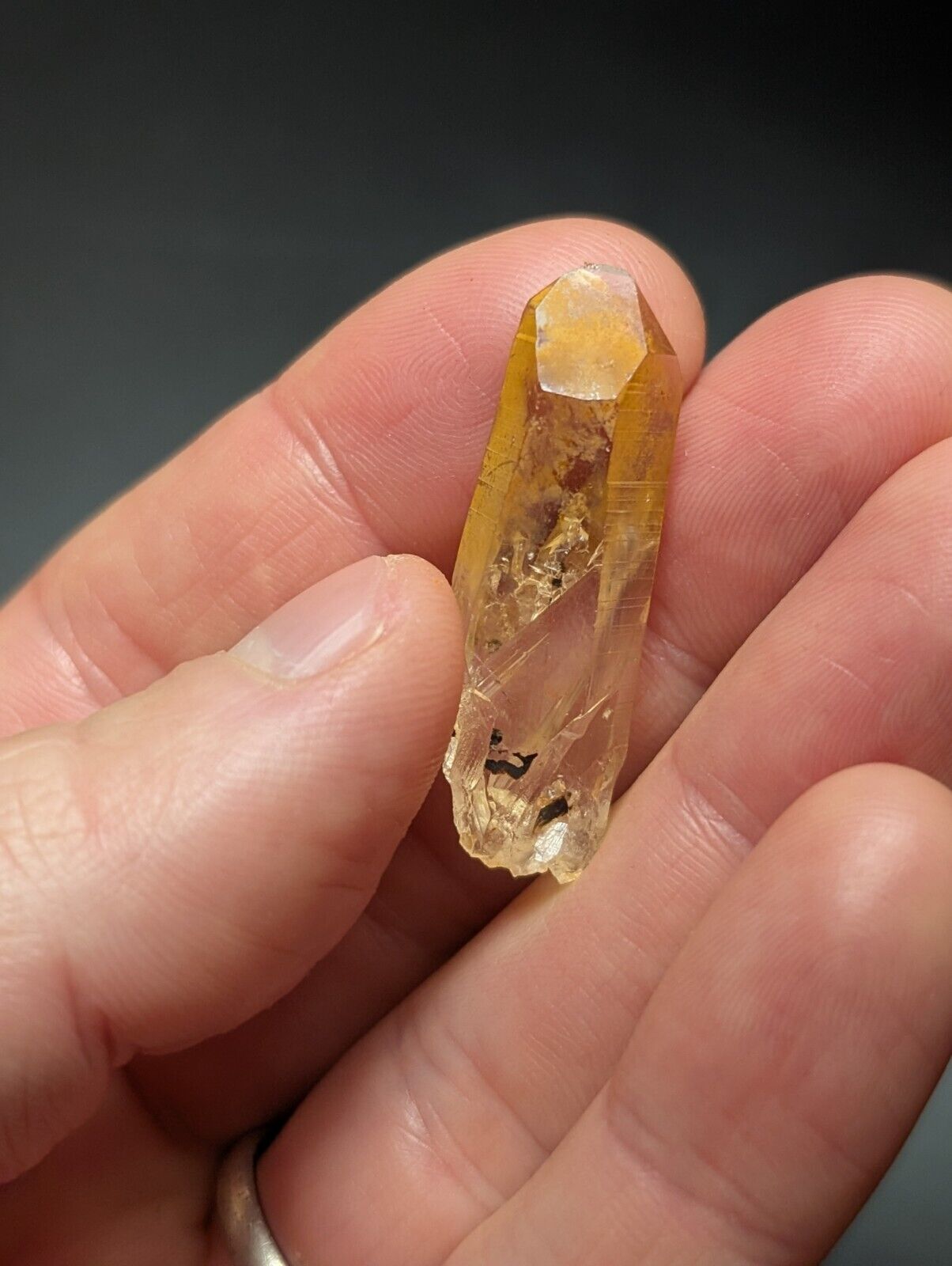 Translucent, yellow-tinted crystal point.