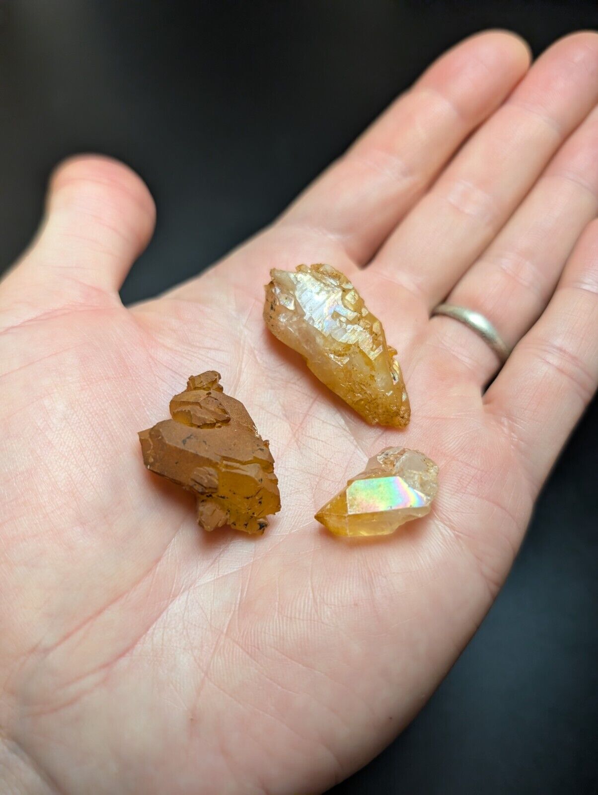Hand holding three crystals.