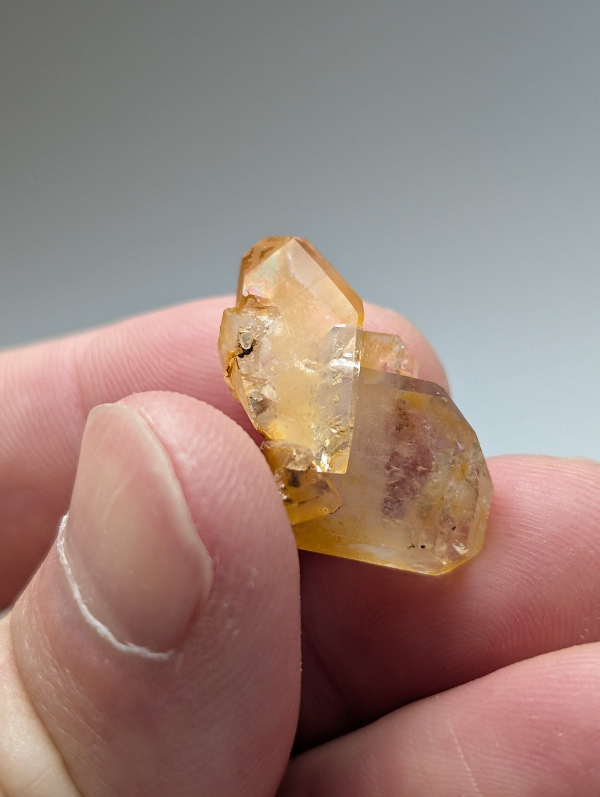 A translucent golden-yellow citrine crystal cluster with faceted geometric structure and natural inclusions in set of 3 Arkansas quartz crystals with natural iridescence unique and OOAK