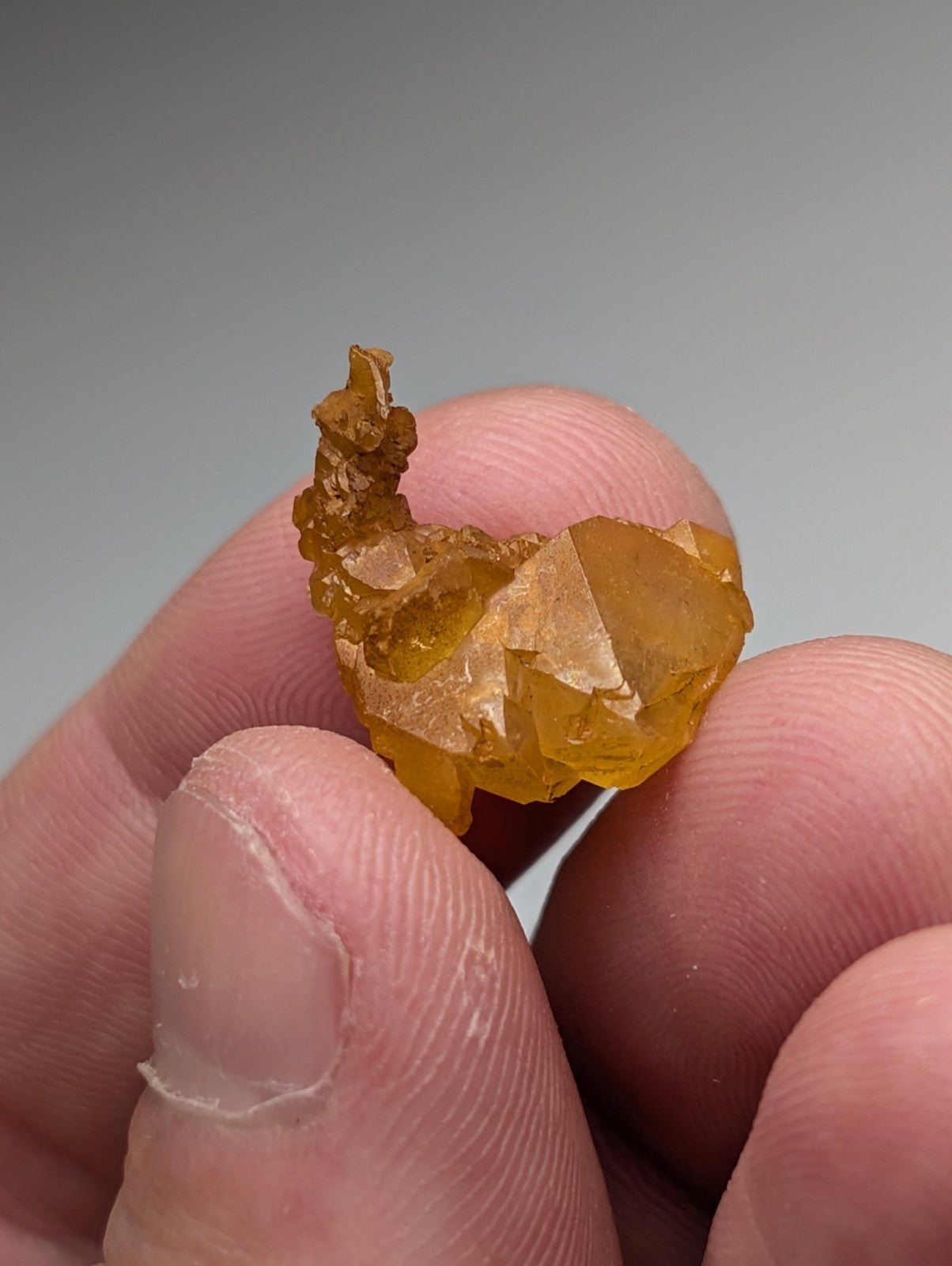 A set of 3 translucent golden-yellow arkansas quartz crystals with natural iridescence and sharp faceted edges
