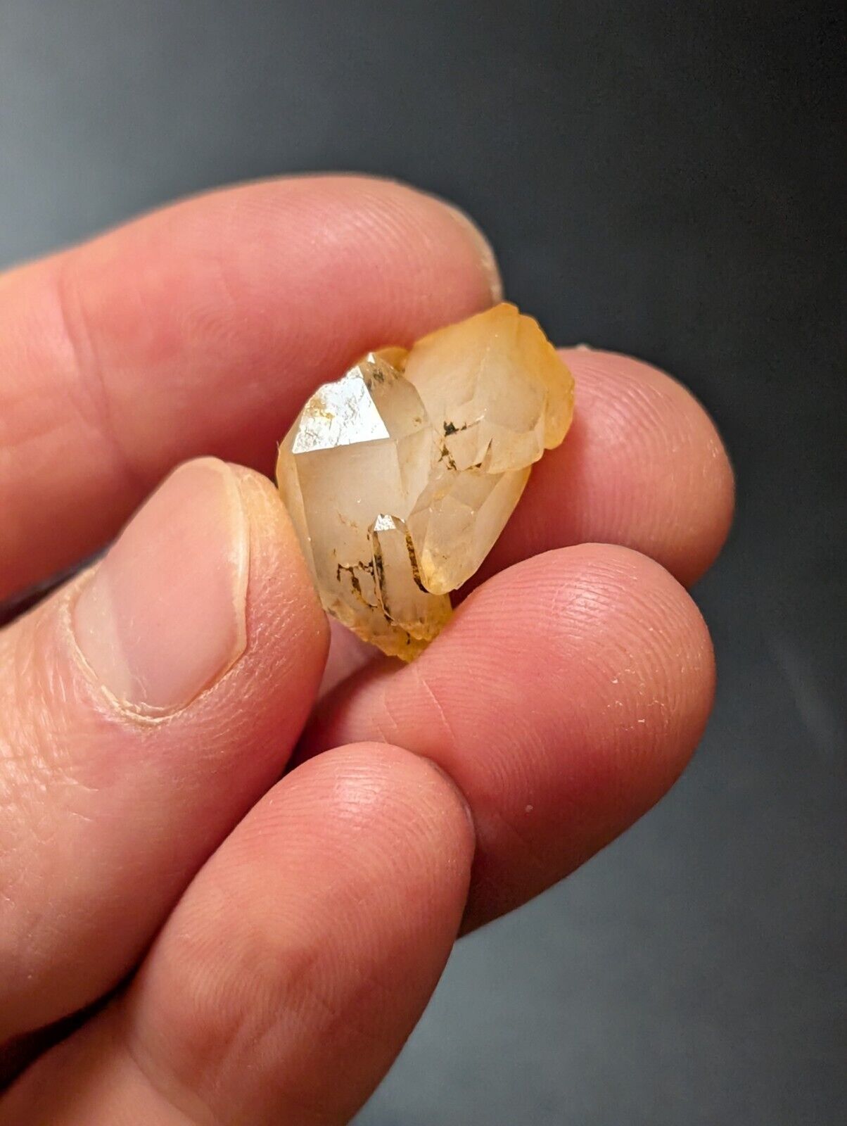Translucent yellow crystal with black inclusions.