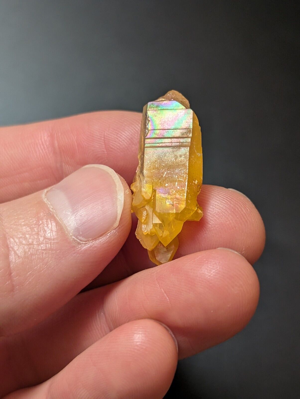 Yellow crystal with iridescent sheen.