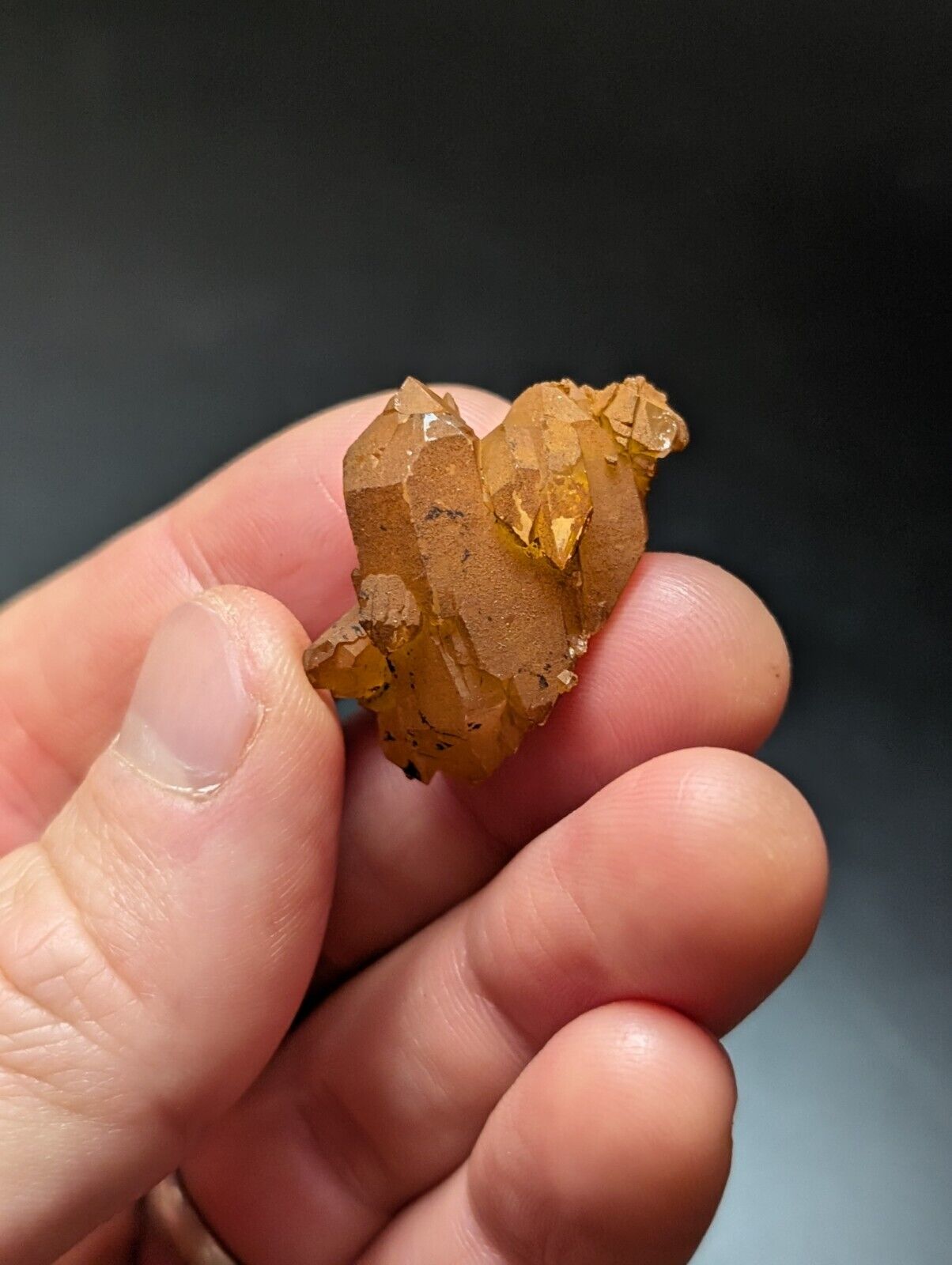 Cluster of orange quartz crystals.