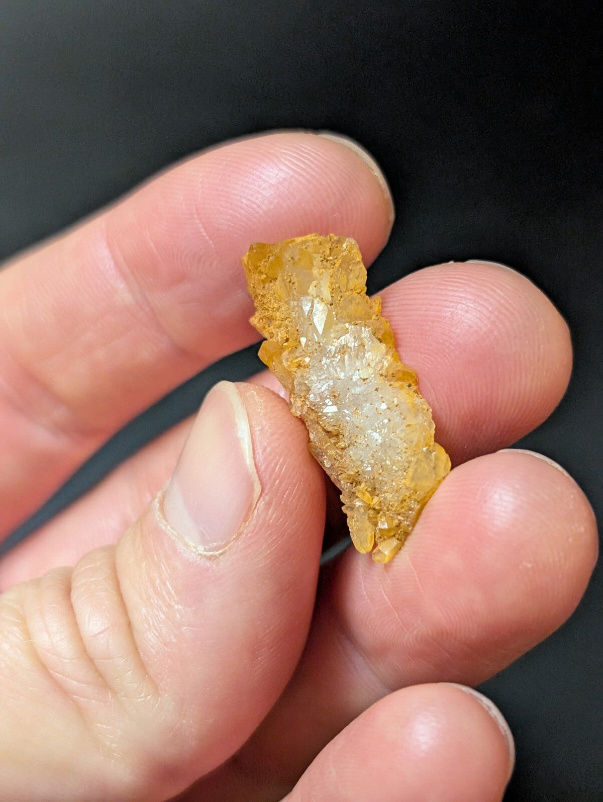 A translucent golden-yellow crystal with a rough, jagged exterior and clear crystalline facets.
