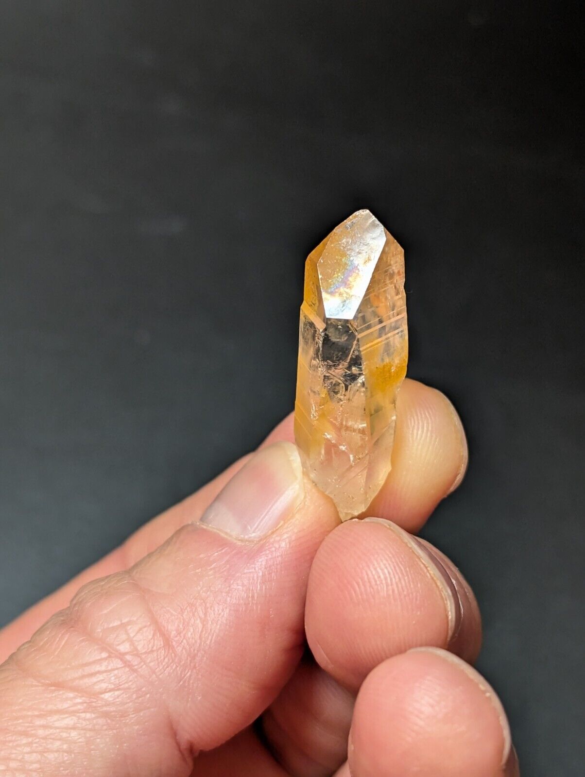 Translucent, orange-tinted quartz crystal.