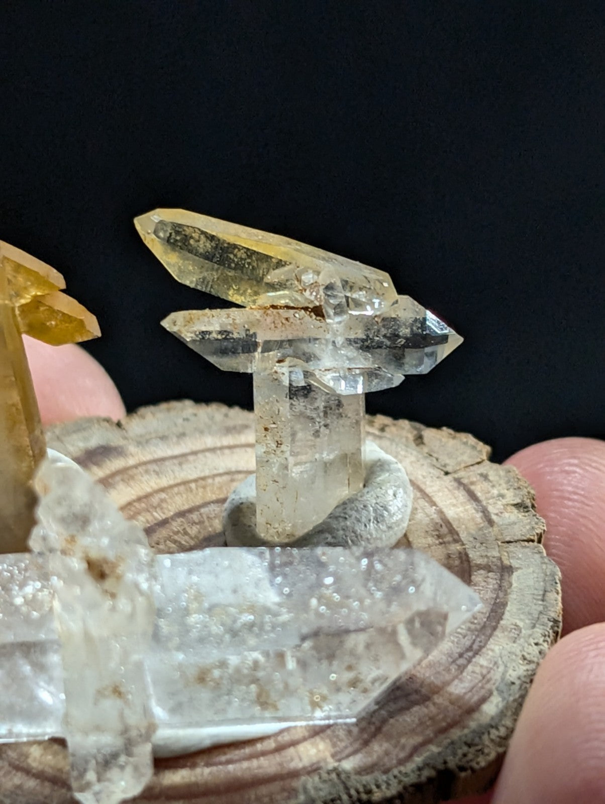 A translucent yellow and clear quartz crystal formation with a natural, faceted structure.