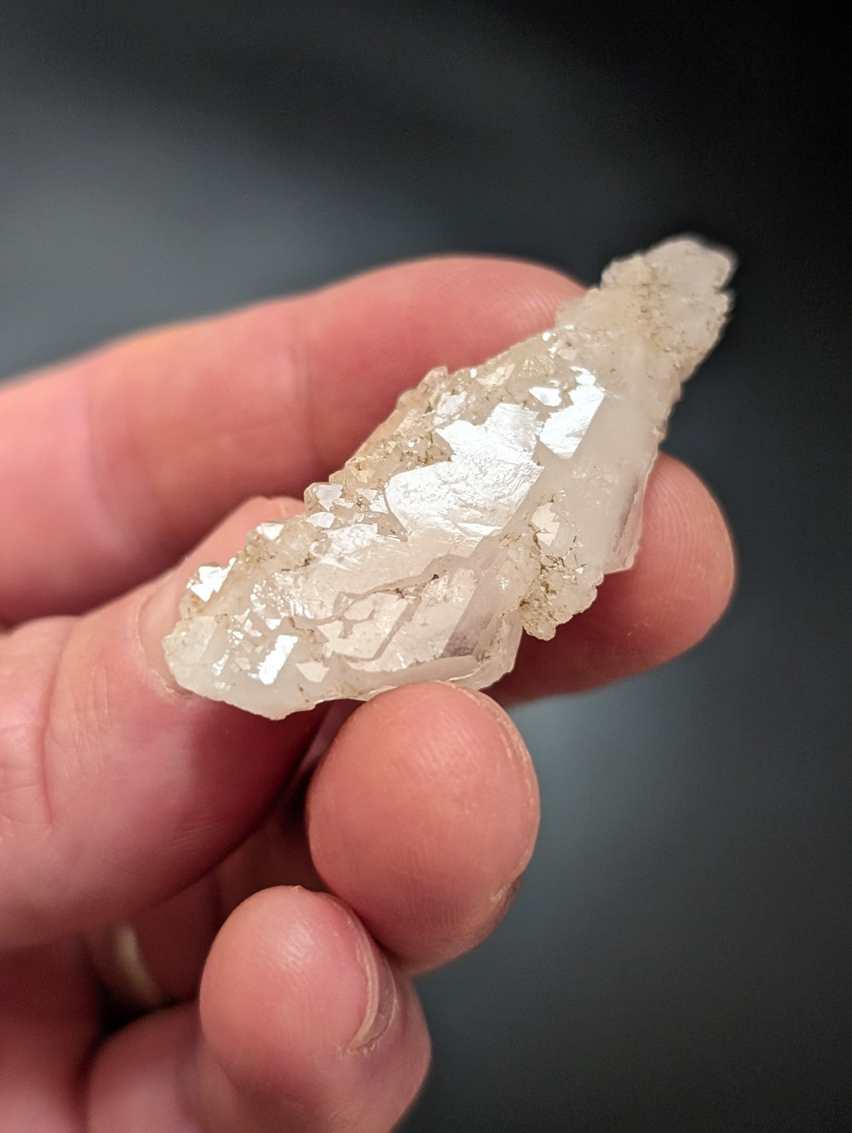 A translucent, crystalline quartz specimen with a rough, jagged surface and subtle internal reflections.