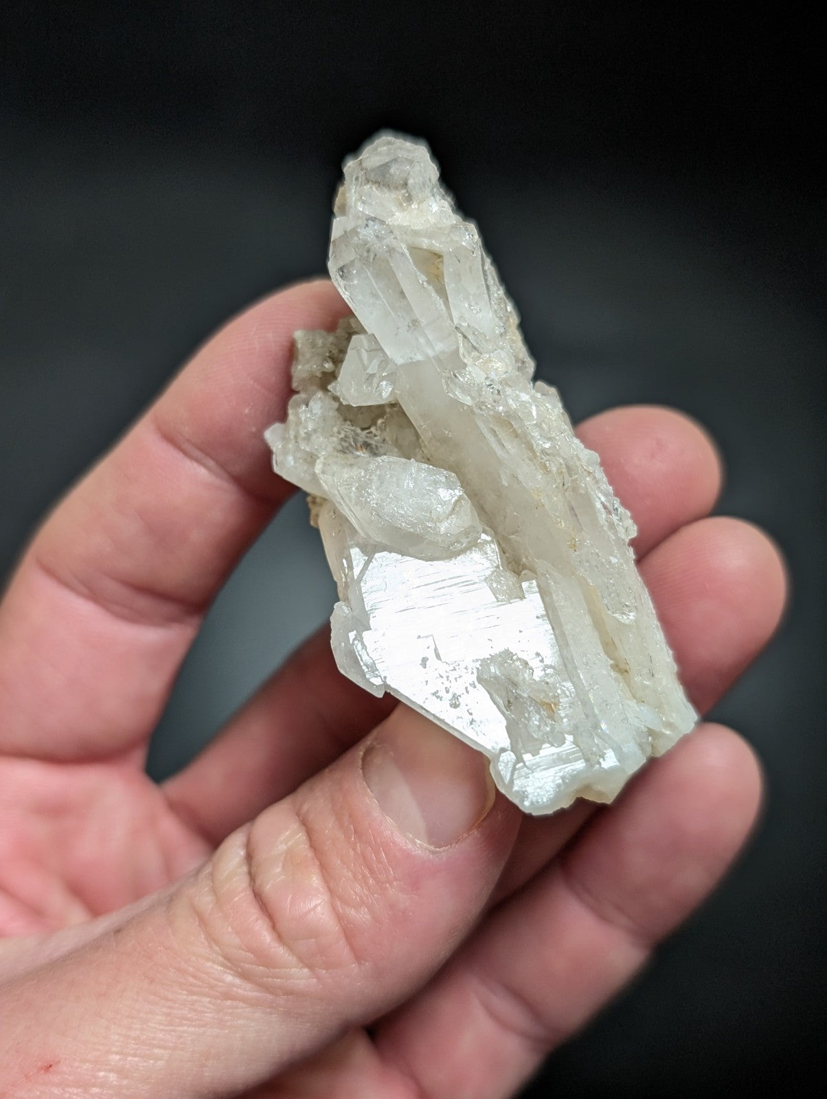 A translucent white quartz crystal cluster with sharp, interlocking facets and a natural, rugged texture.