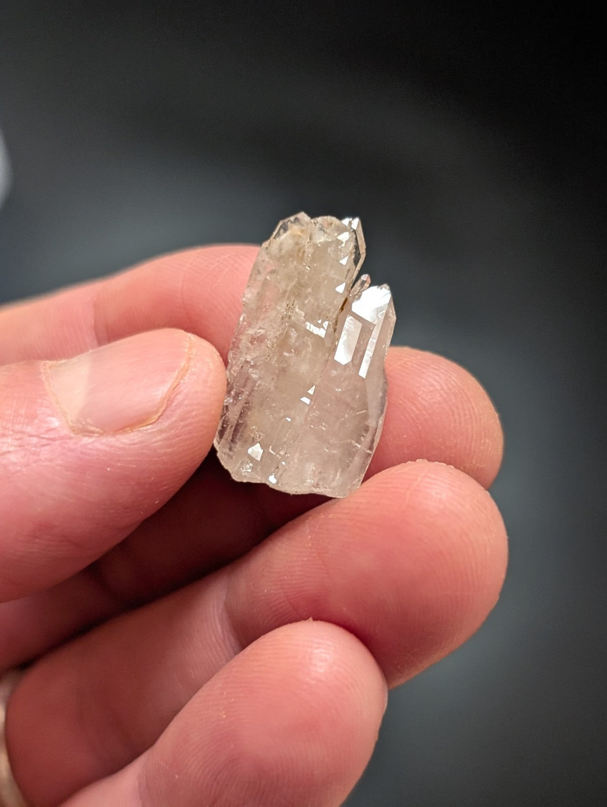 A translucent, clear quartz crystal cluster with sharp facets and a natural, irregular shape.
