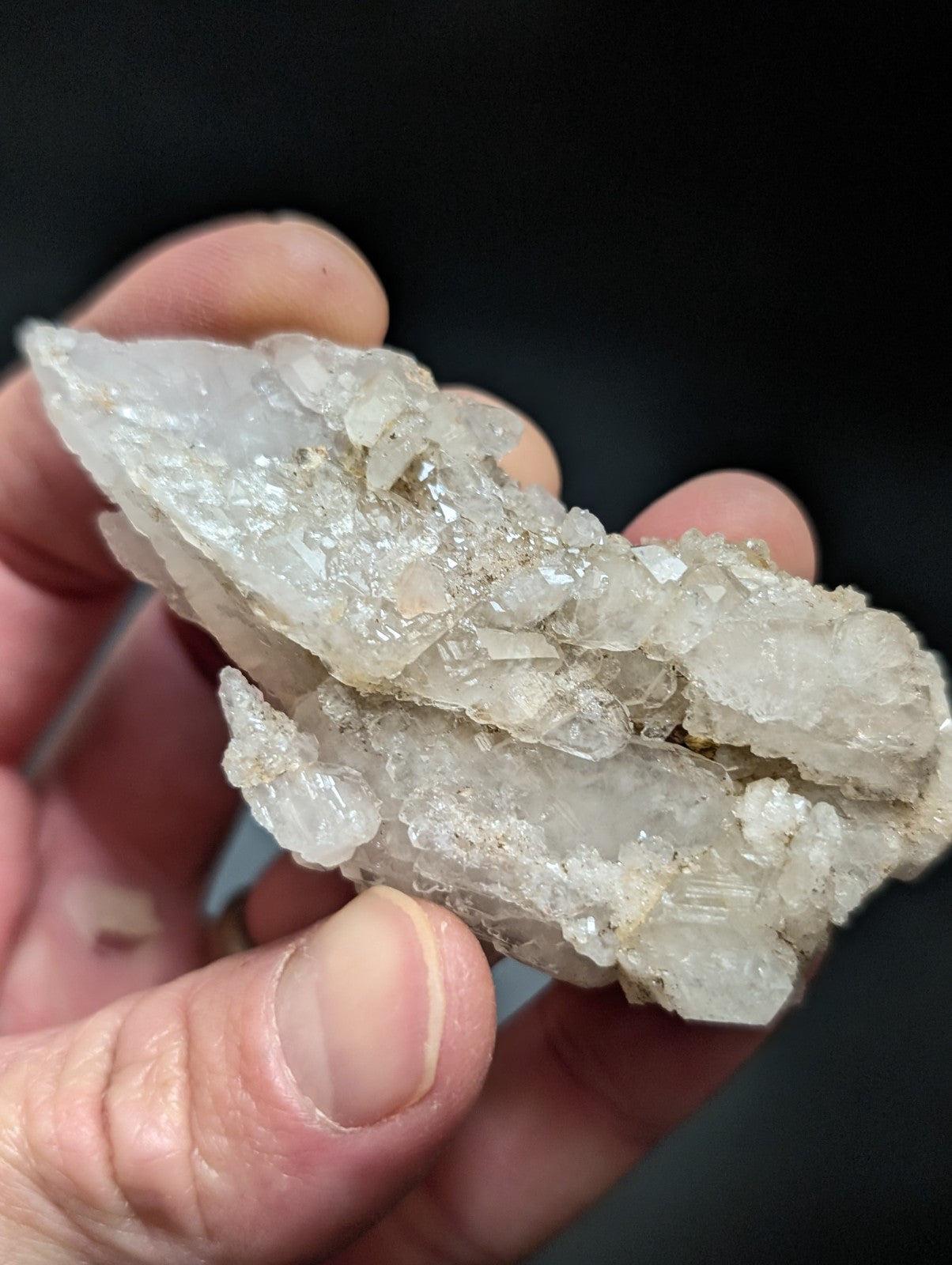 A translucent, crystalline quartz geode cluster with a mix of clear and slightly cloudy facets.