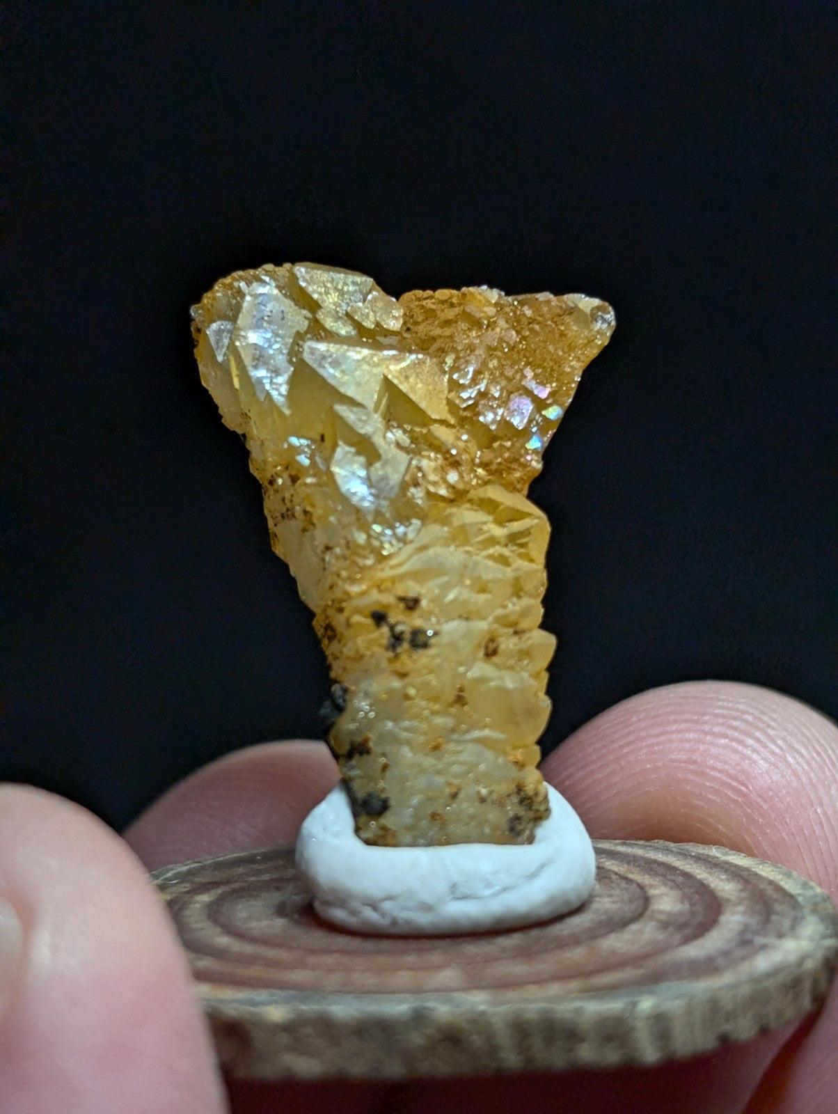 A translucent golden-yellow mineral specimen with crystalline facets and a rough, textured surface.