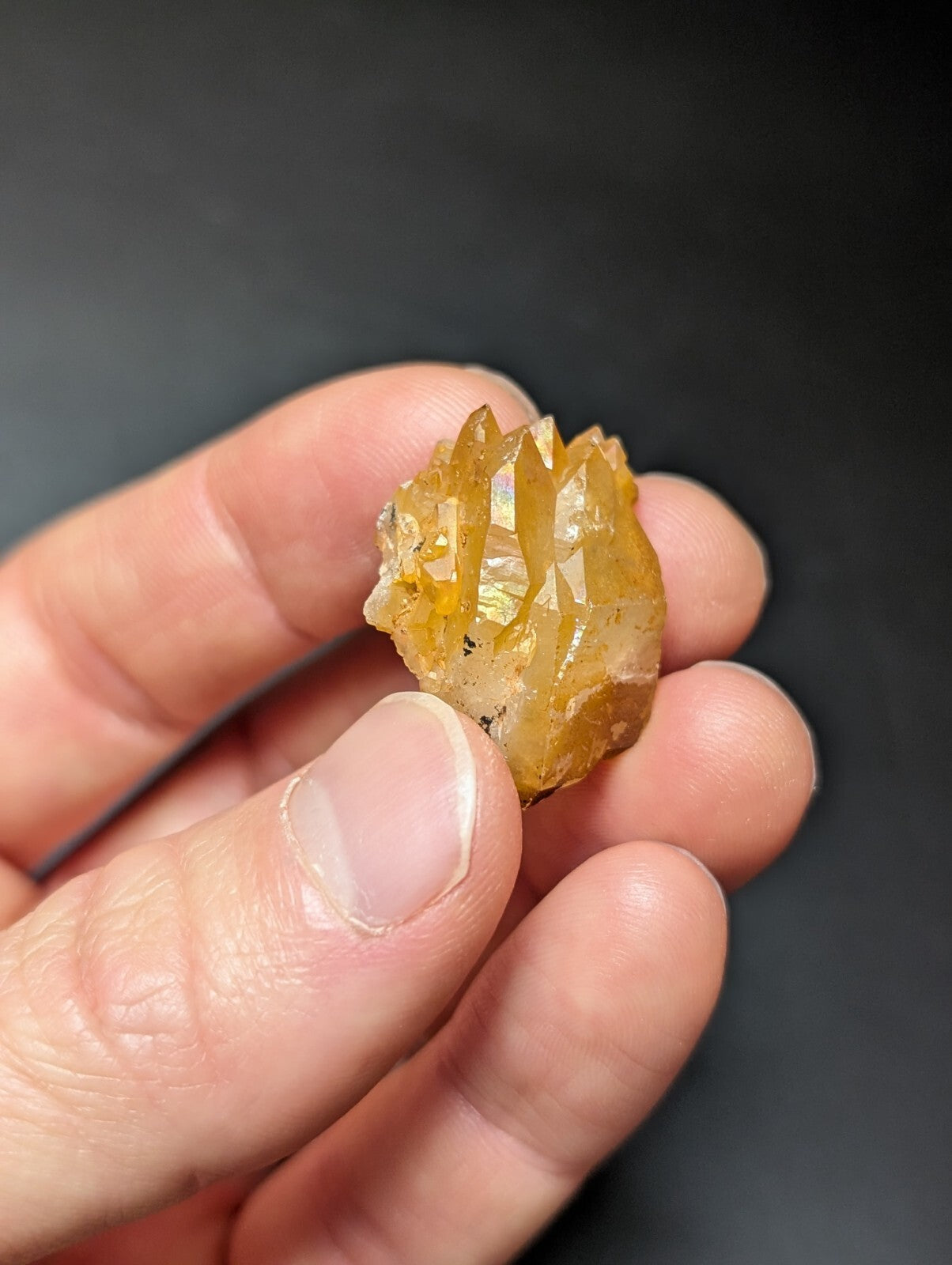 A translucent golden-yellow crystal cluster with sharp, faceted points and a slightly rough, natural surface.