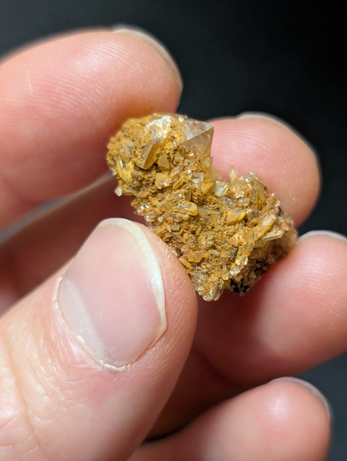 A golden-yellow quartz crystal cluster with translucent facets and earthy matrix.