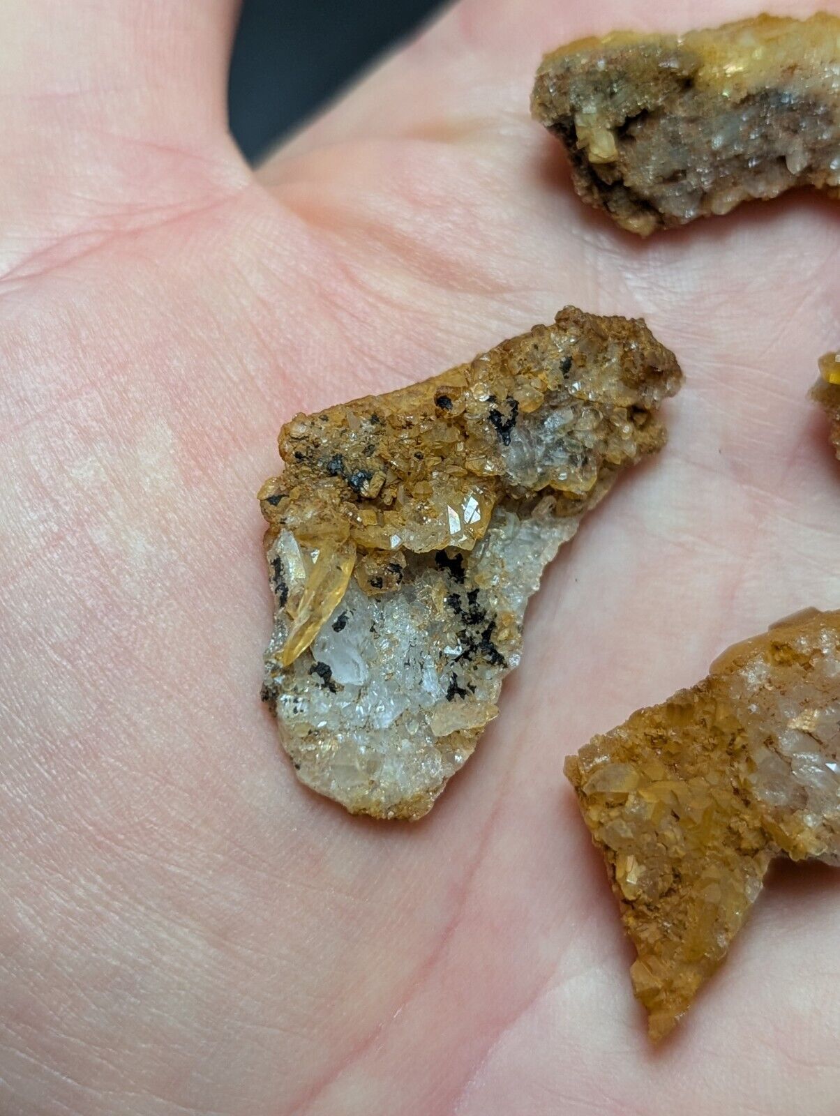 Rough mineral specimens with crystalline structures.