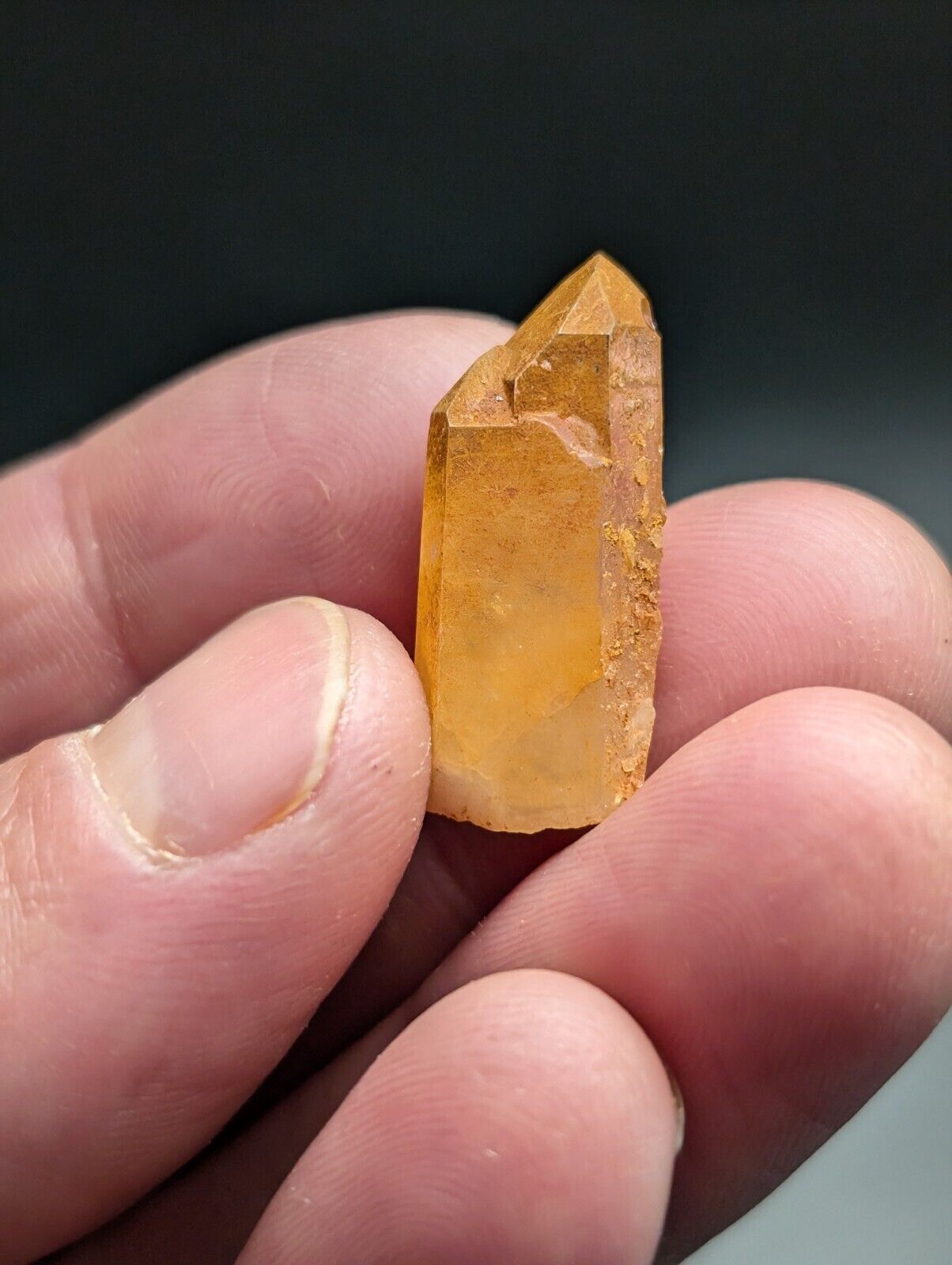 Translucent orange crystal point.
