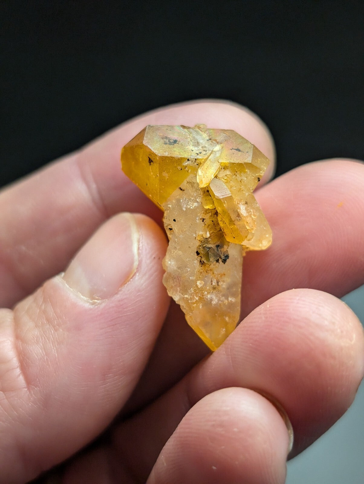 A translucent yellow crystal with a faceted, geometric structure and subtle inclusions.