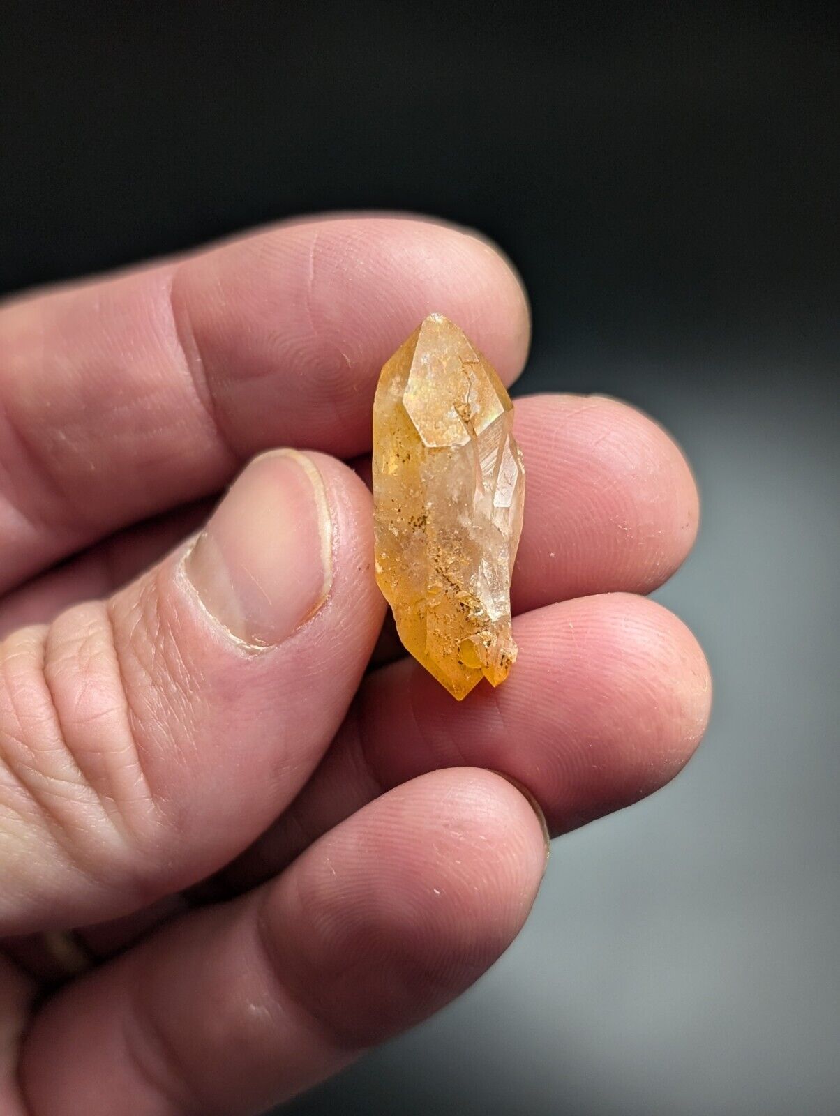 Translucent orange crystal point.
