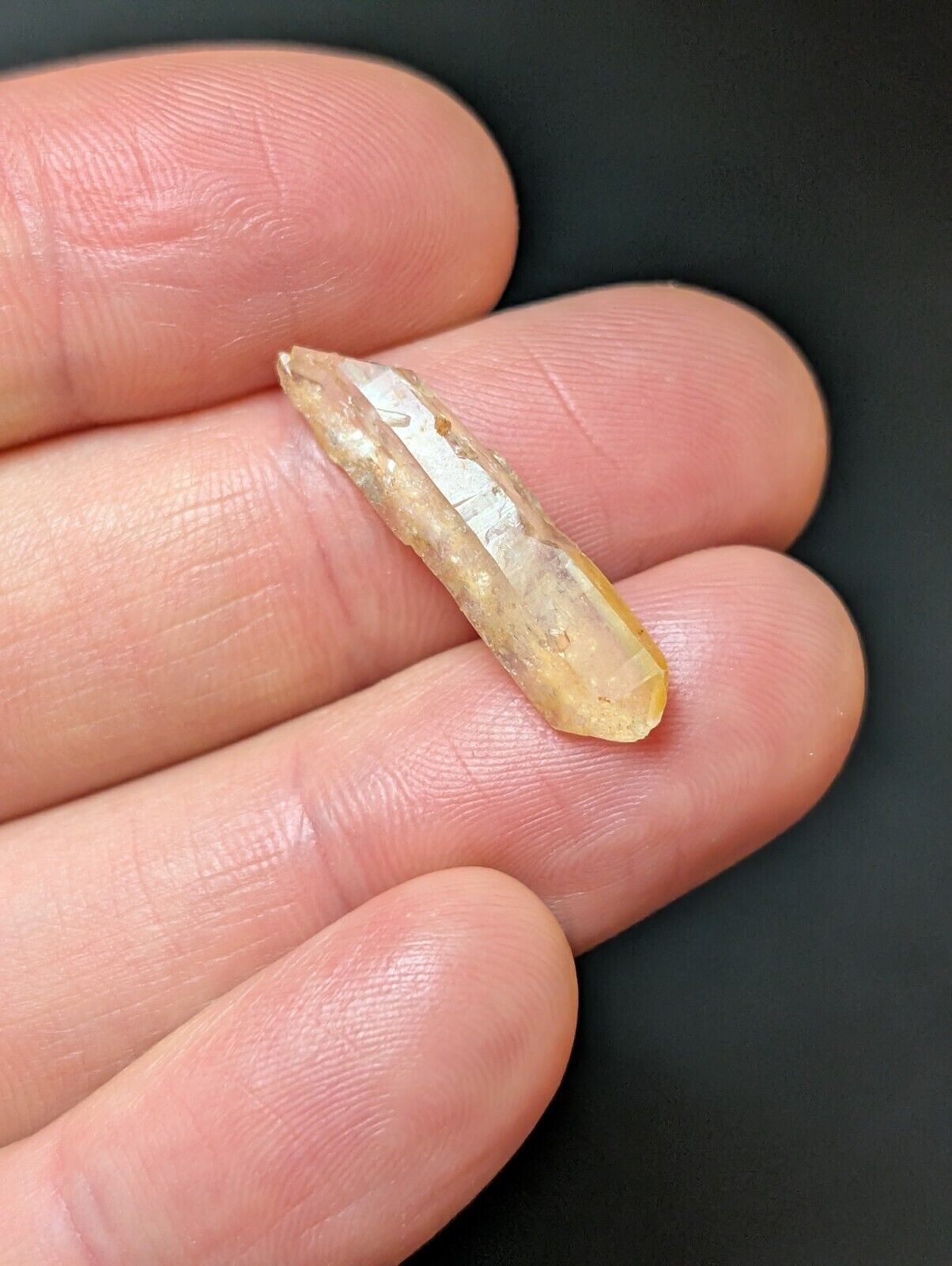 Translucent, yellowish crystal point.