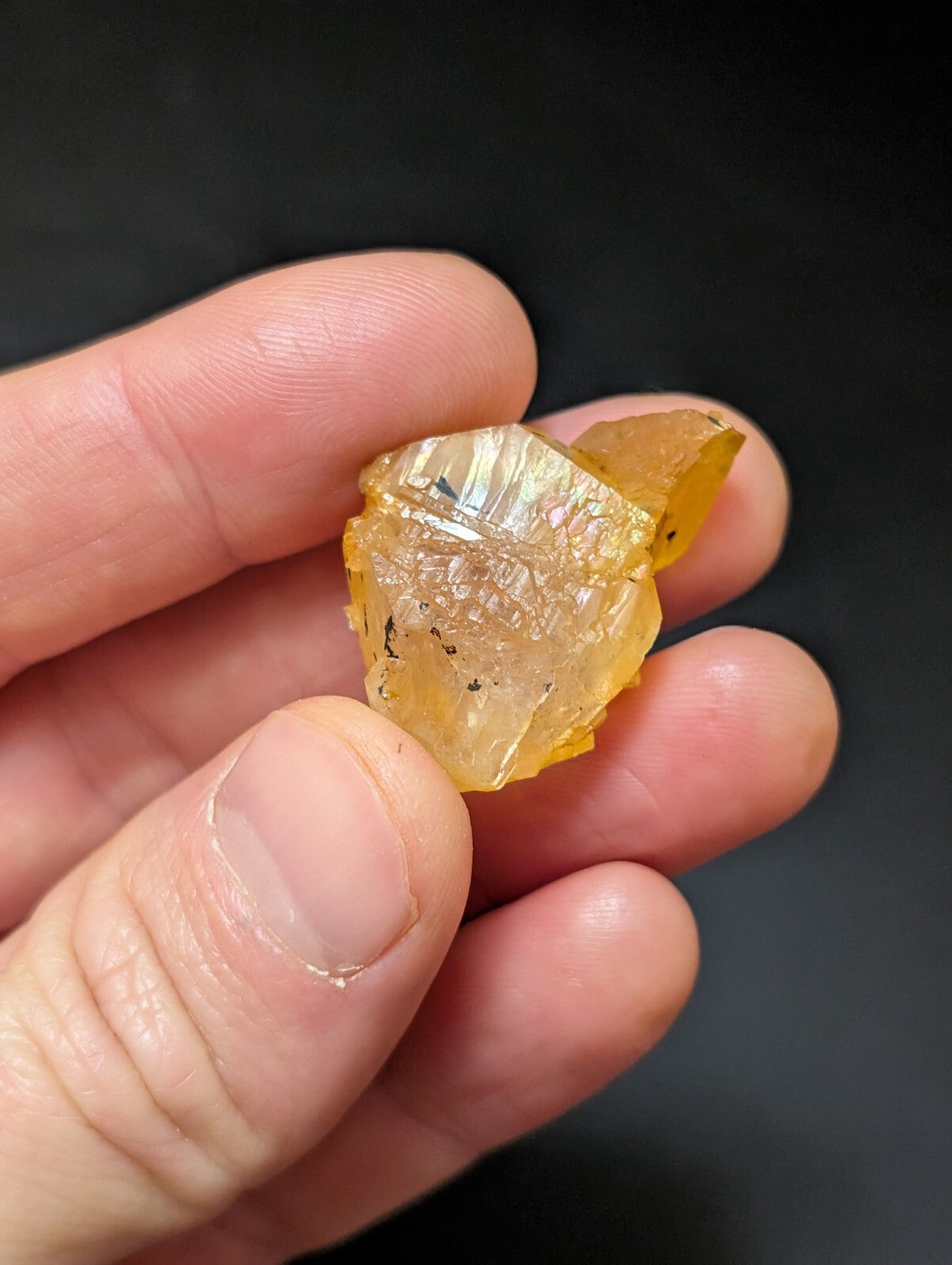 A translucent golden-yellow crystal with a rough, faceted surface and subtle internal inclusions.