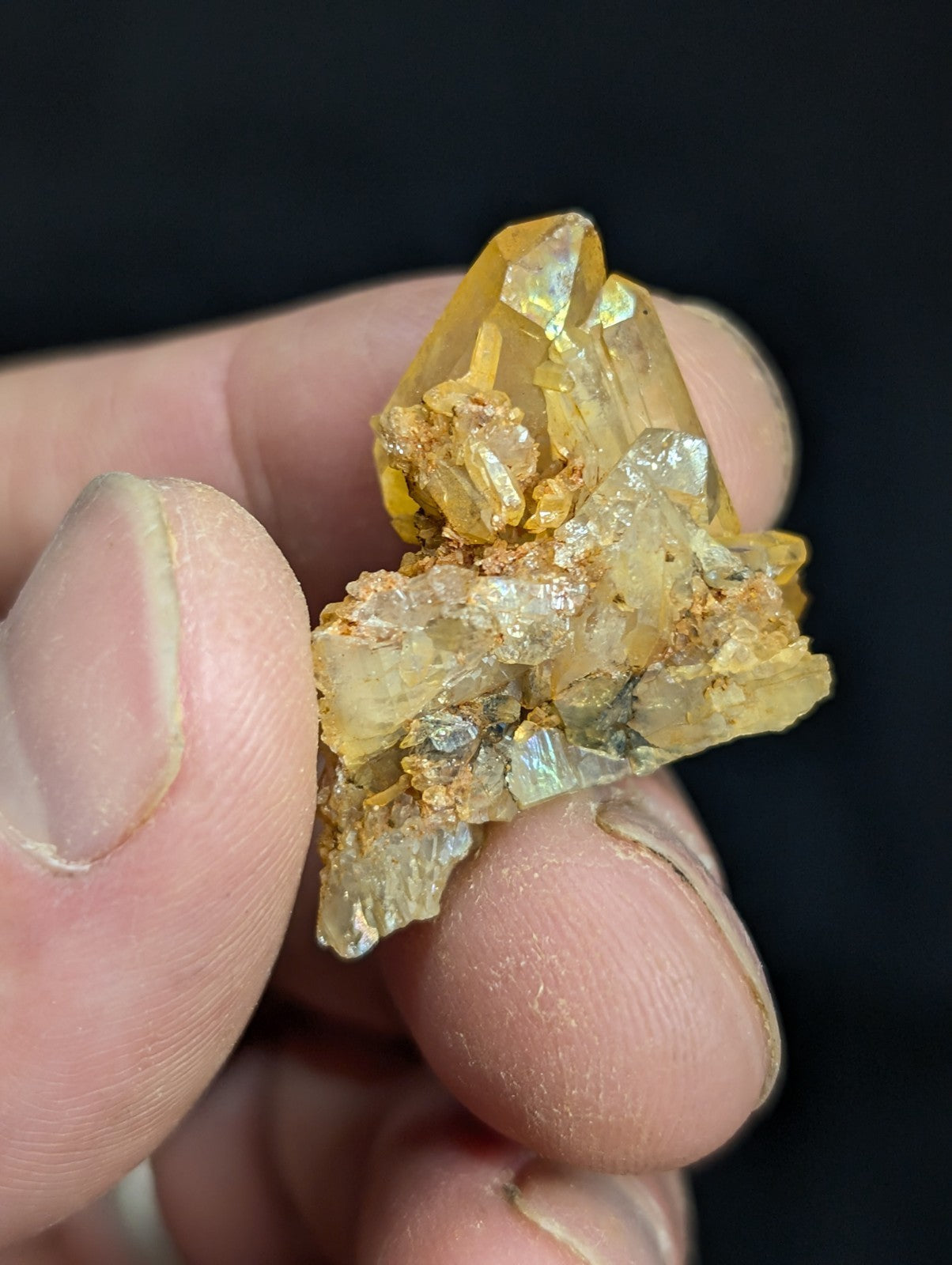 A translucent golden-yellow crystal cluster with sharp, faceted points and a rougher base.