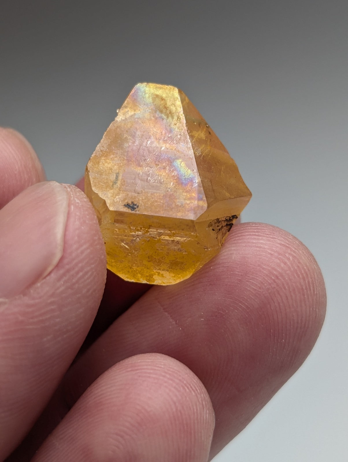 A faceted translucent yellow arkansas quartz crystal with natural iridescence from a set of 6 unique ooak stones