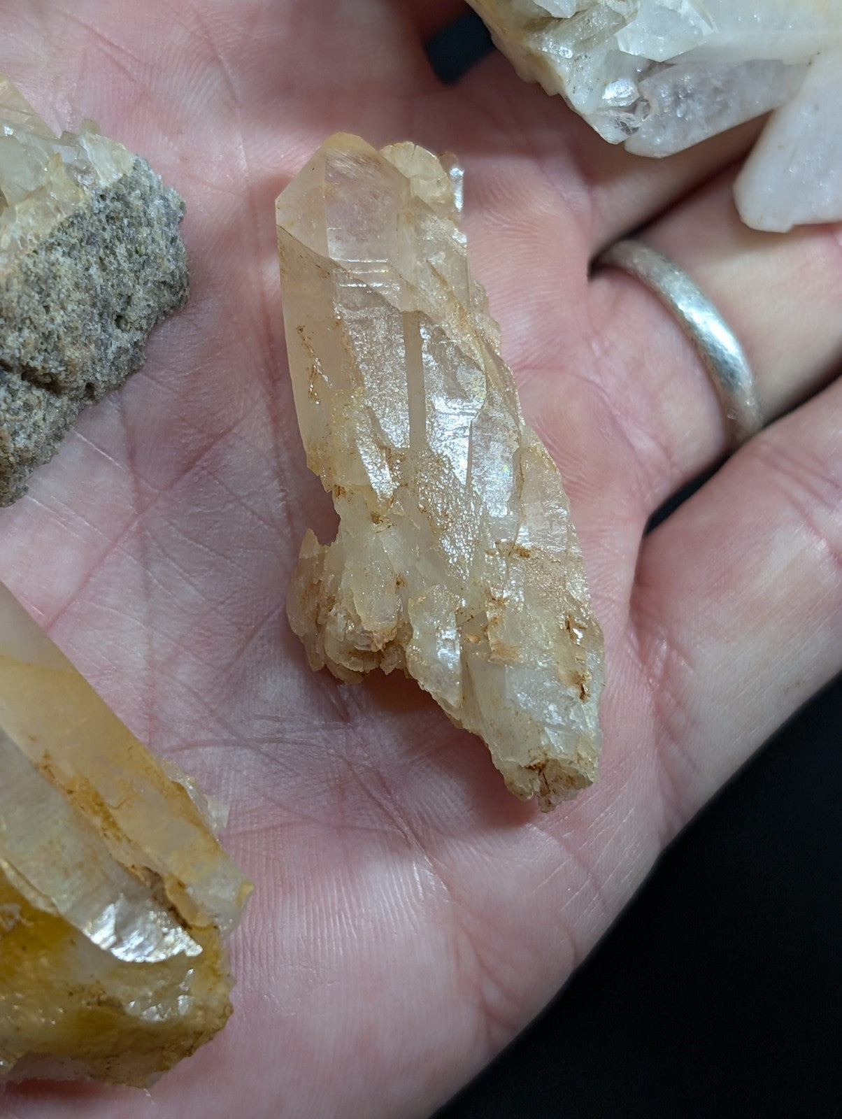 A translucent, amber-hued quartz crystal with a rough, natural texture and visible internal striations.