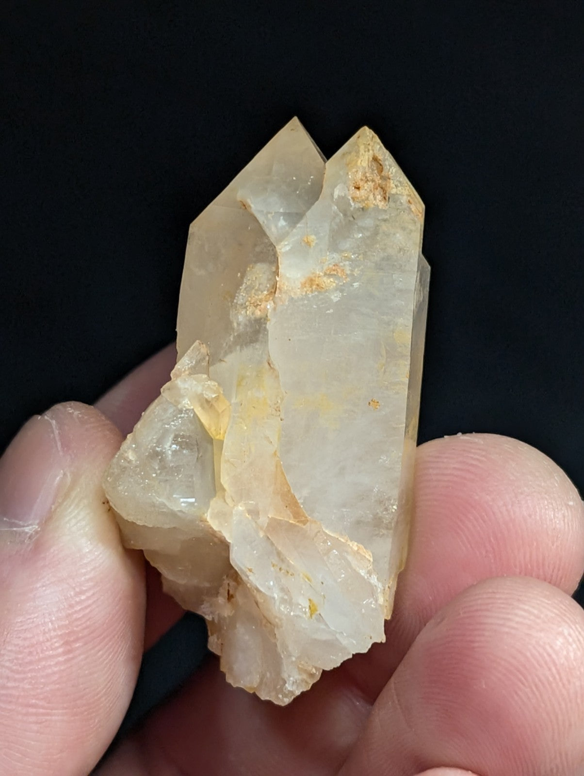 A translucent, pale yellow quartz crystal cluster with natural facets and subtle golden inclusions.