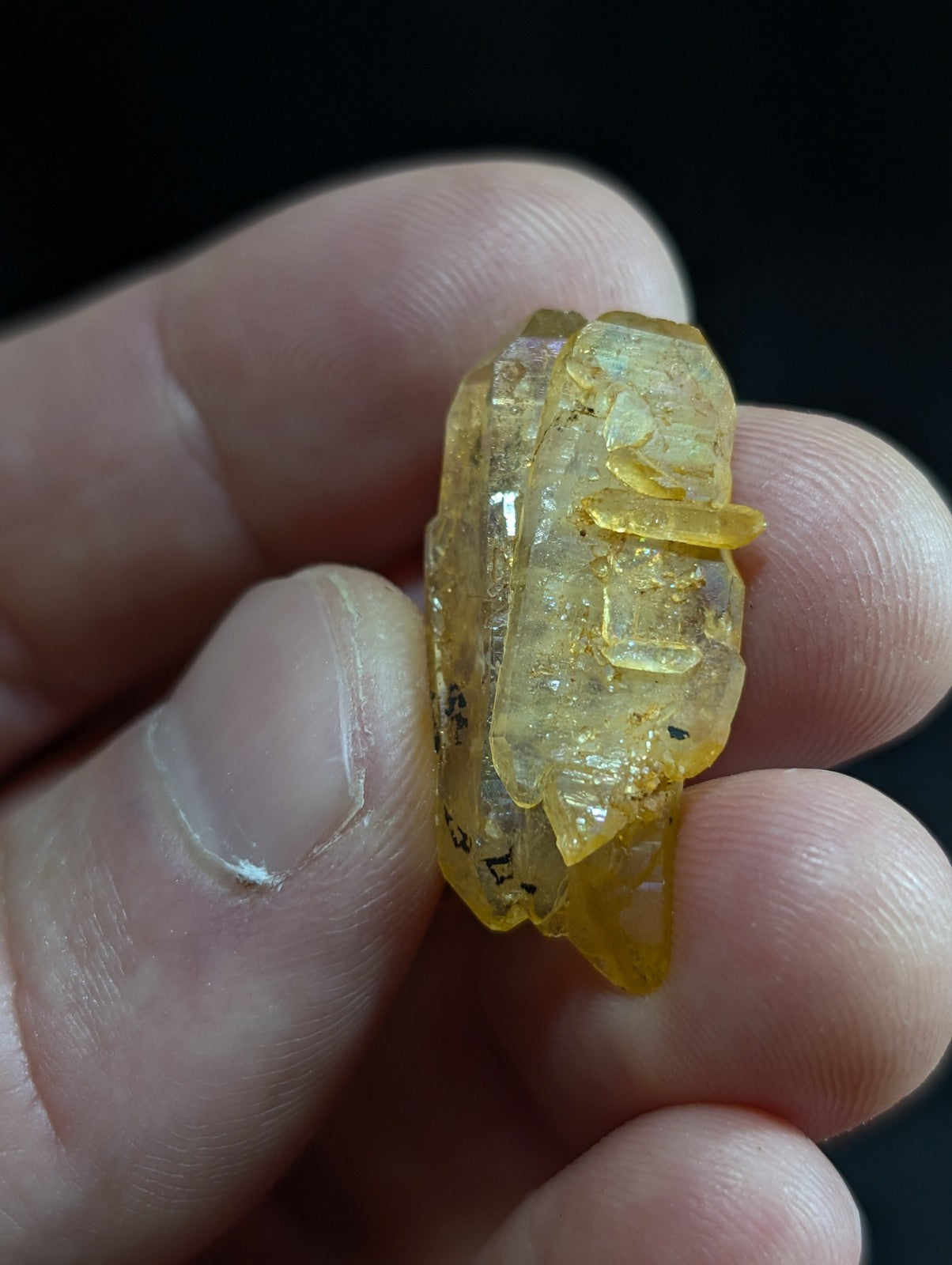 A translucent yellow crystal with a rough, natural formation and visible internal inclusions.
