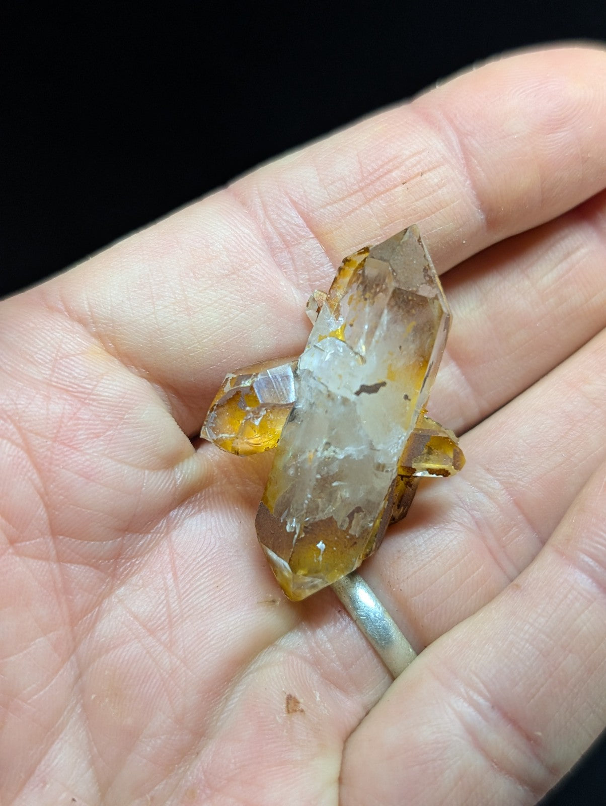 A translucent amber-hued quartz crystal cluster with a faceted, geometric structure and natural inclusions.