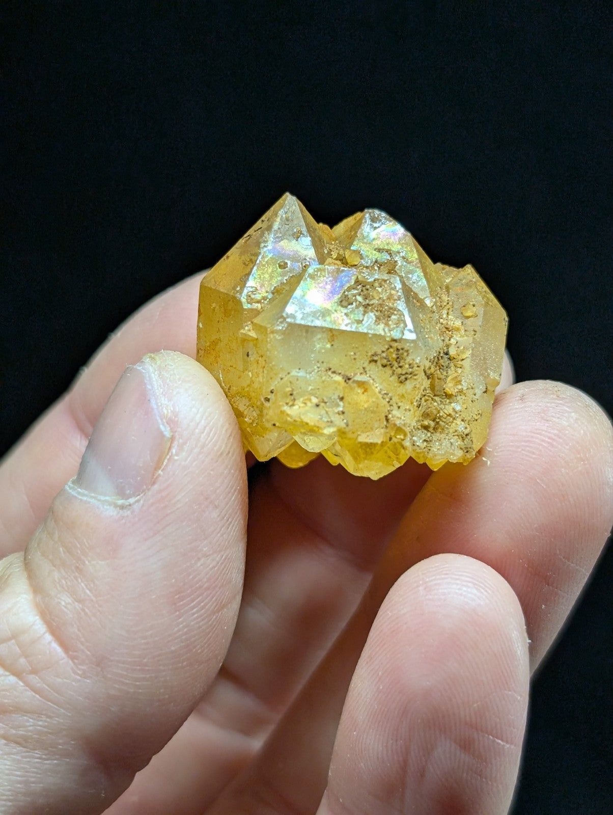 A translucent golden-yellow crystal cluster with sharp, faceted points and a slightly rough surface.