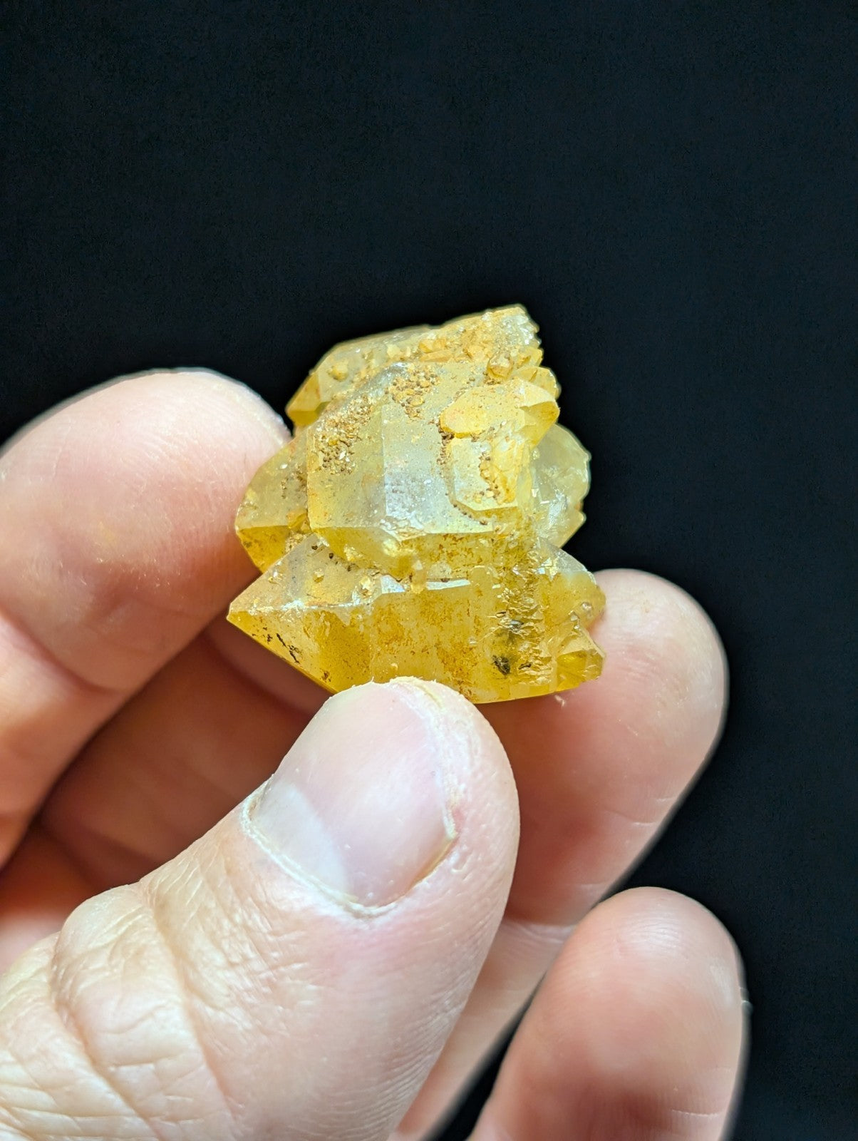A translucent yellow crystal cluster with jagged edges and a slightly cloudy, amber-hued appearance.