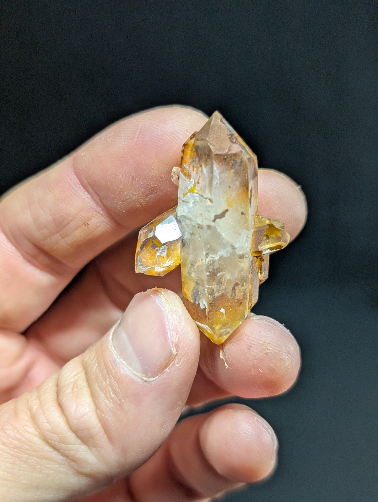 A translucent golden-yellow citrine crystal cluster with sharp, faceted points and natural inclusions.