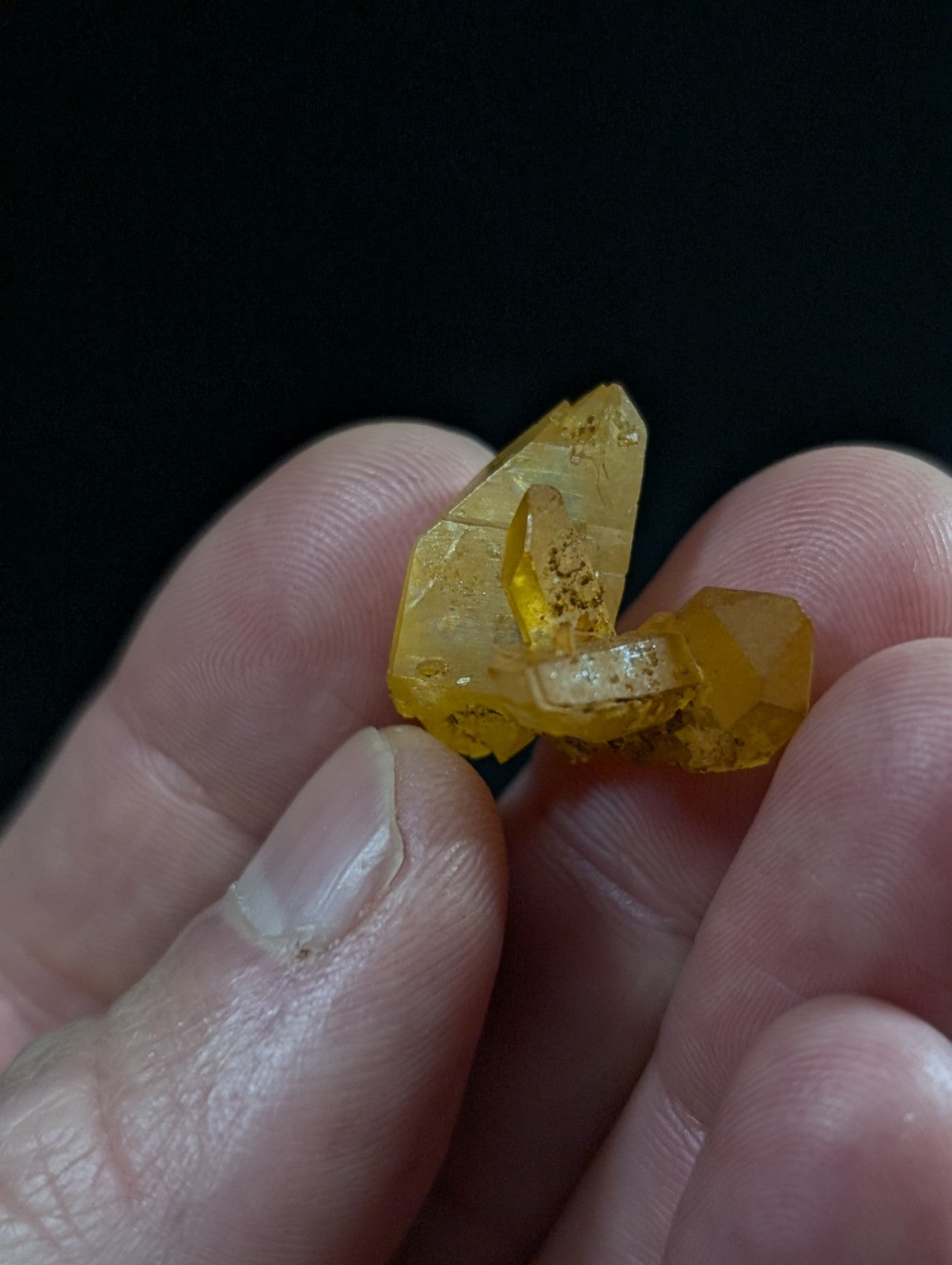 A translucent golden-yellow crystal cluster with sharp, faceted edges and internal inclusions.