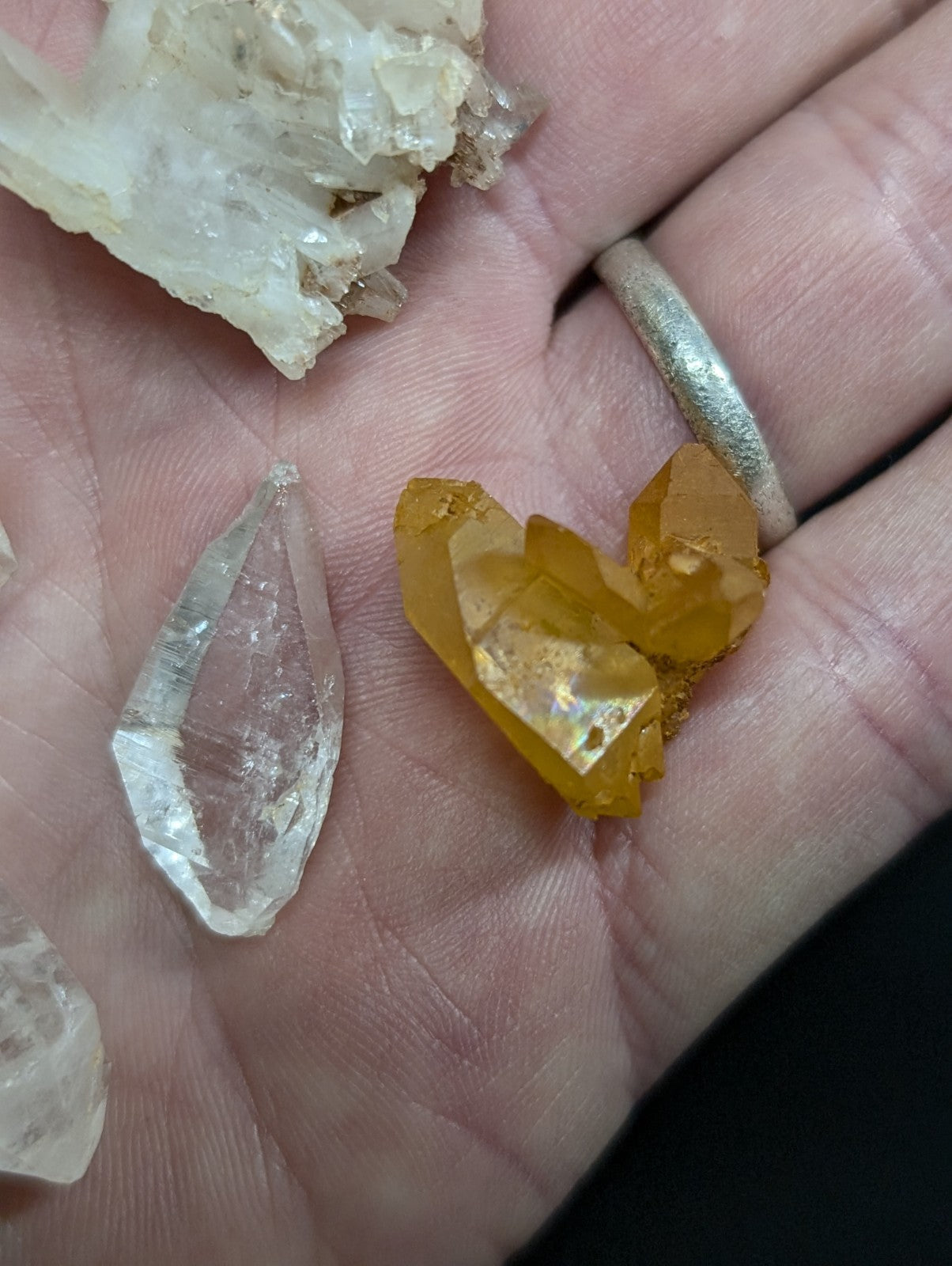 A cluster of translucent yellow citrine crystals with a faceted, natural growth pattern.