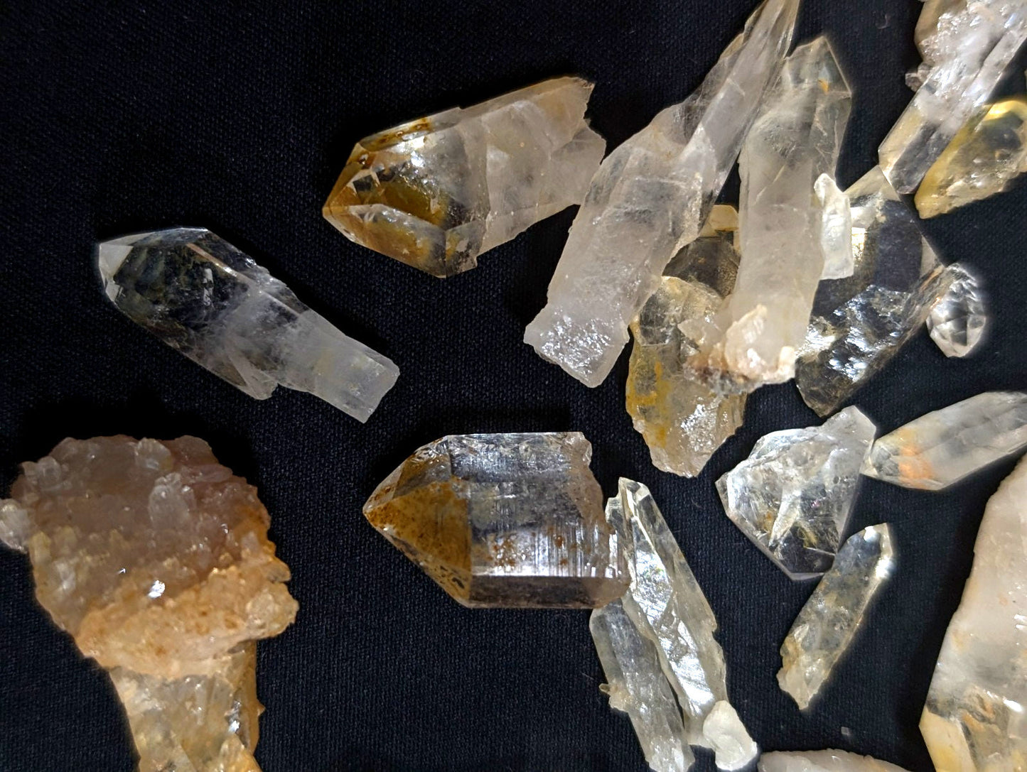 Clear and golden-yellow quartz crystals with sharp, faceted points.