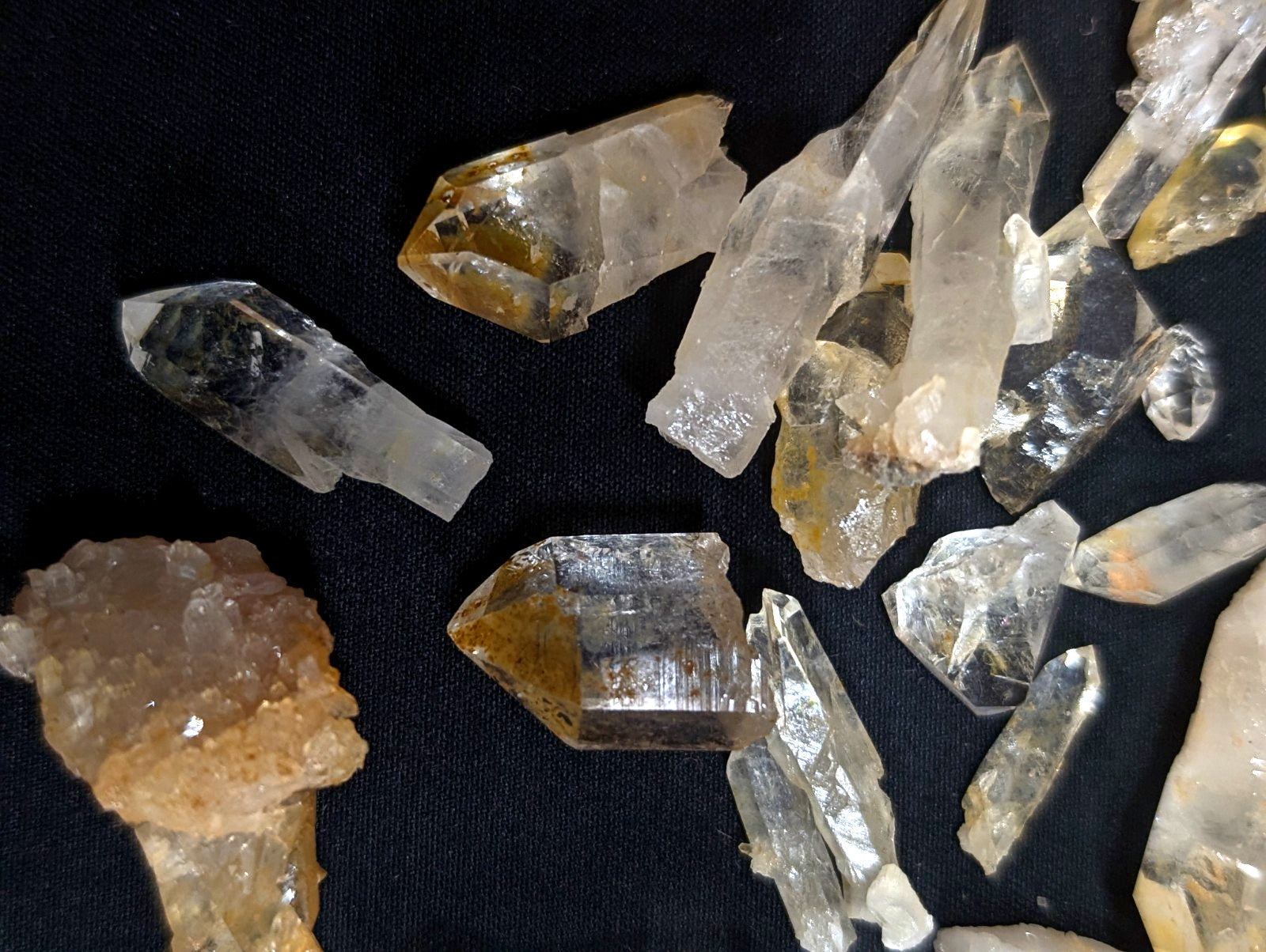 Clear and golden-yellow quartz crystals with sharp, faceted points.